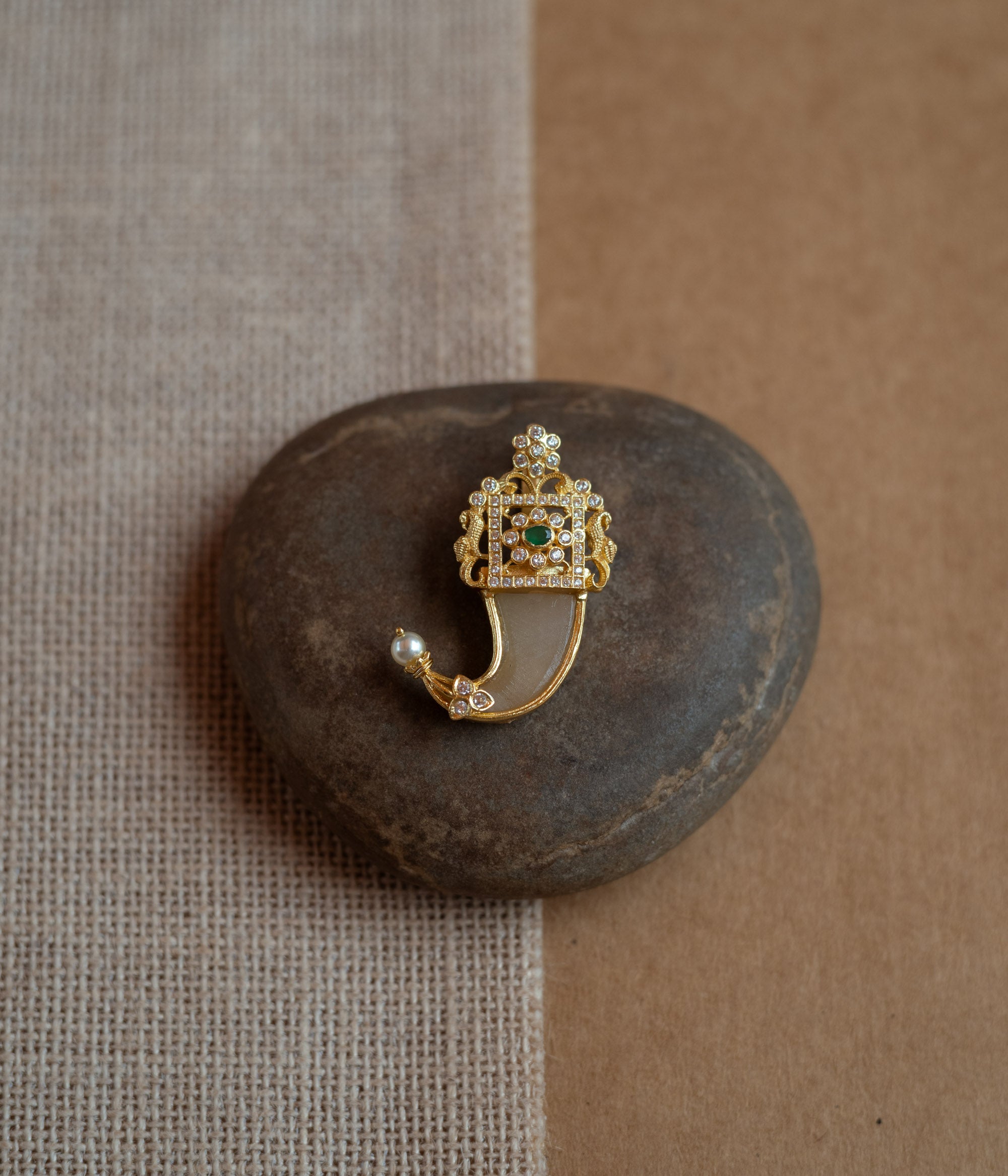 Gold amulet-shaped pendant with a prominent green spinel stone, CZ stones, and pearl drops.