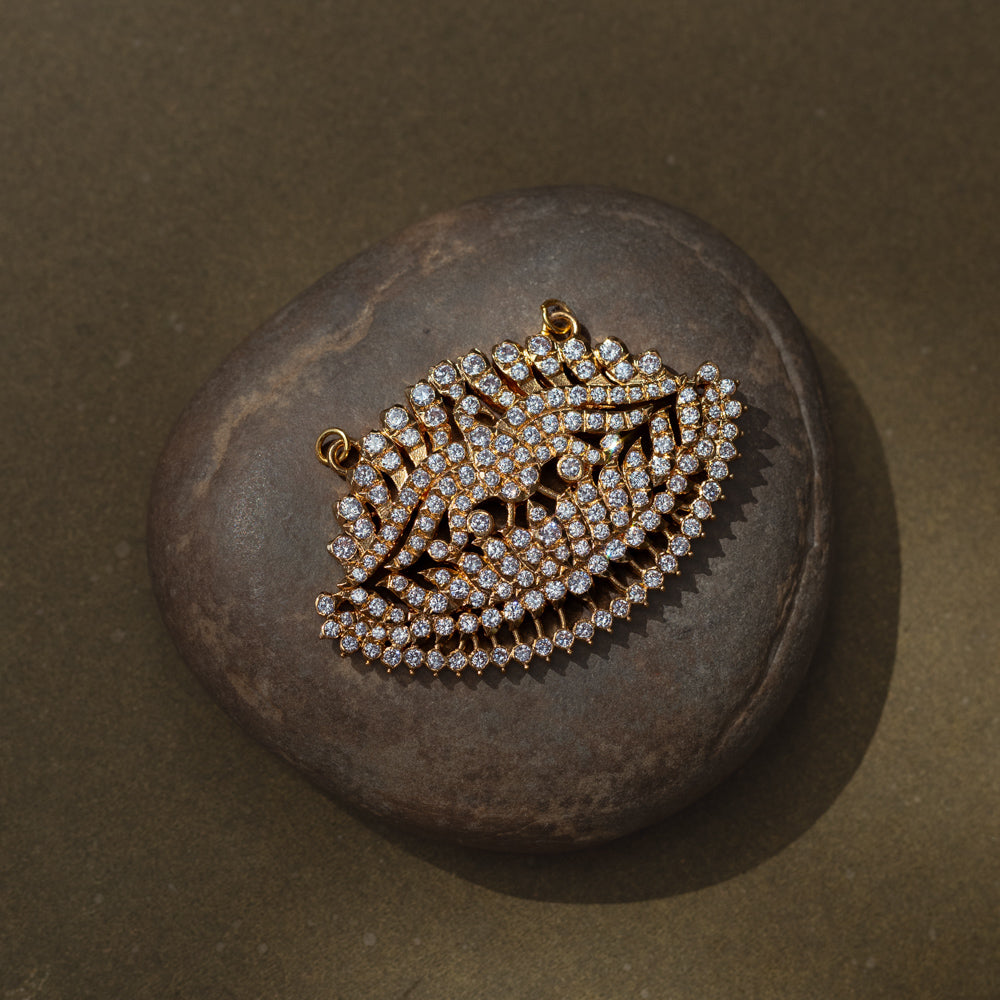 Leaf-shaped gold pendant encrusted with CZ stones from Stone Collection, symbolizing nature and elegance.