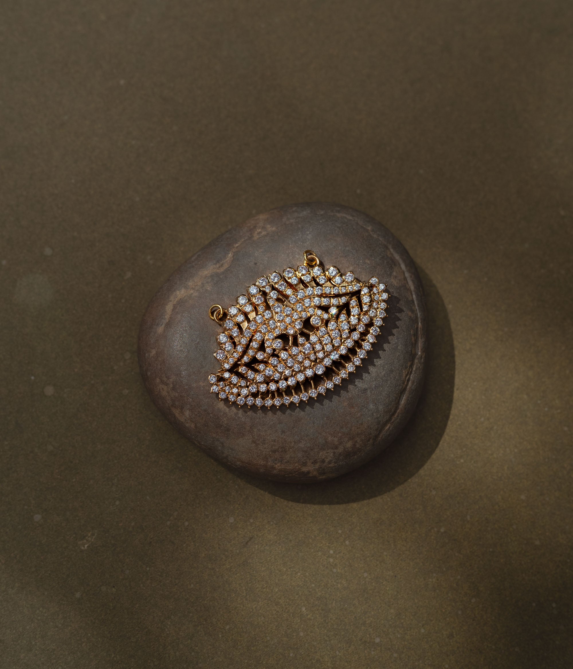 Leaf-shaped gold pendant encrusted with CZ stones from Stone Collection, symbolizing nature and elegance.