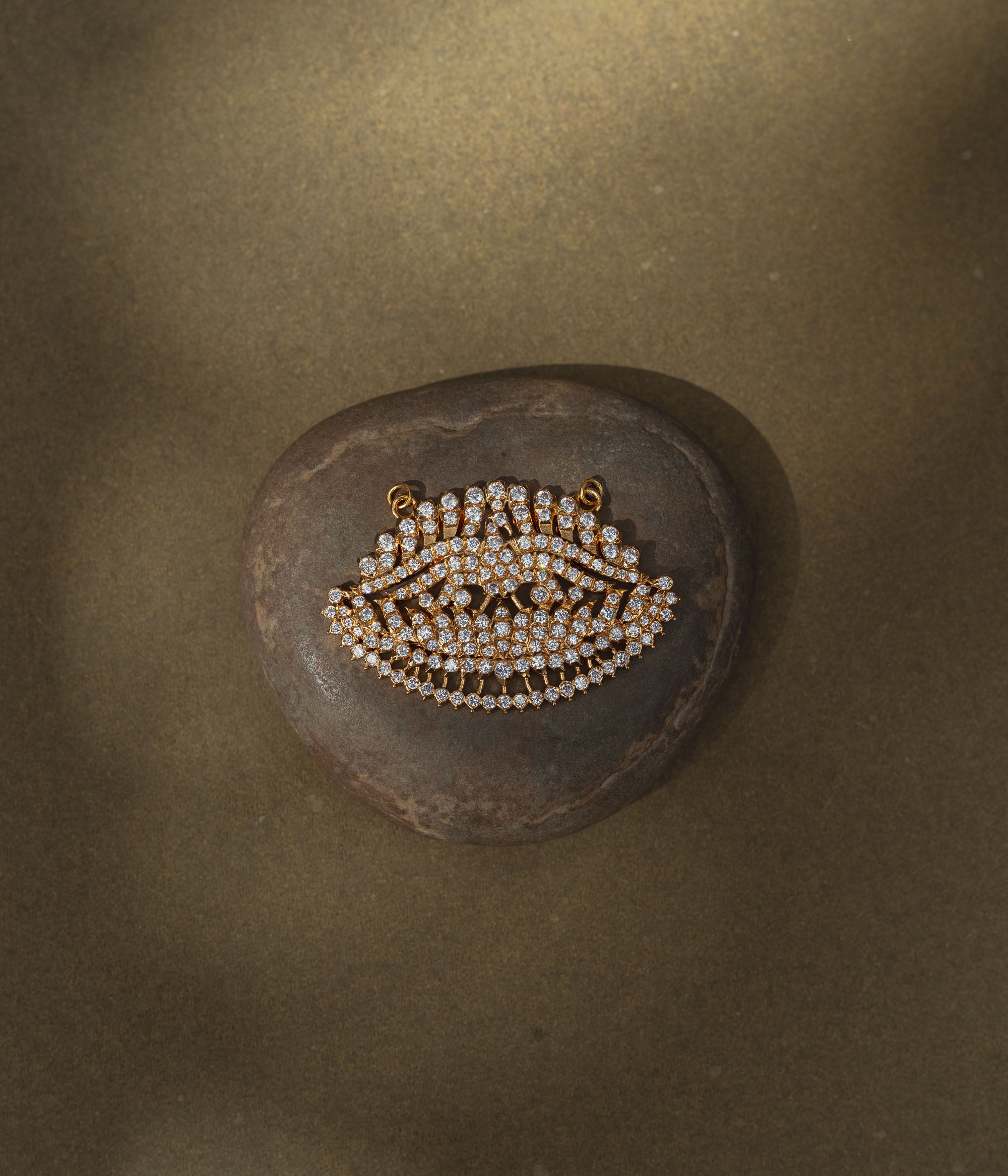 Leaf-shaped gold pendant encrusted with CZ stones from Stone Collection, symbolizing nature and elegance.