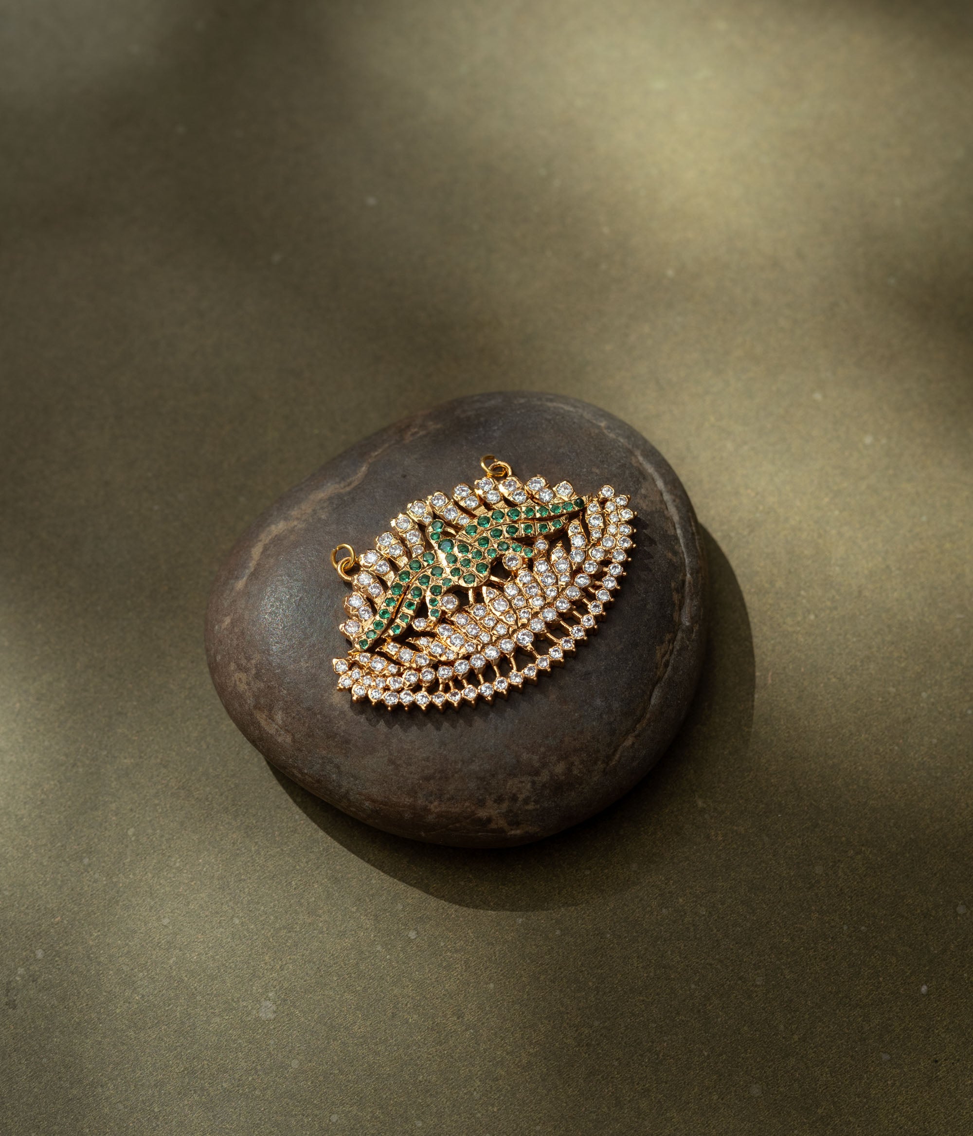 Gold pendant with CZ and green stones in feathered wing shape from the Stone Collection.