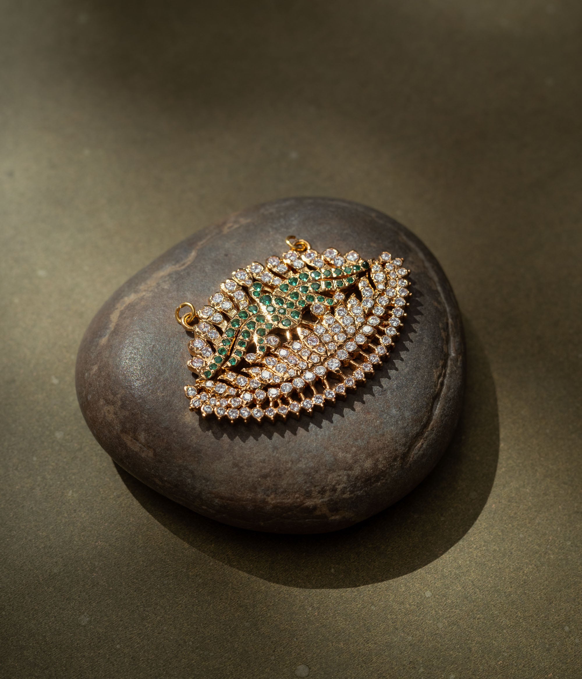 Gold pendant with CZ and green stones in feathered wing shape from the Stone Collection.