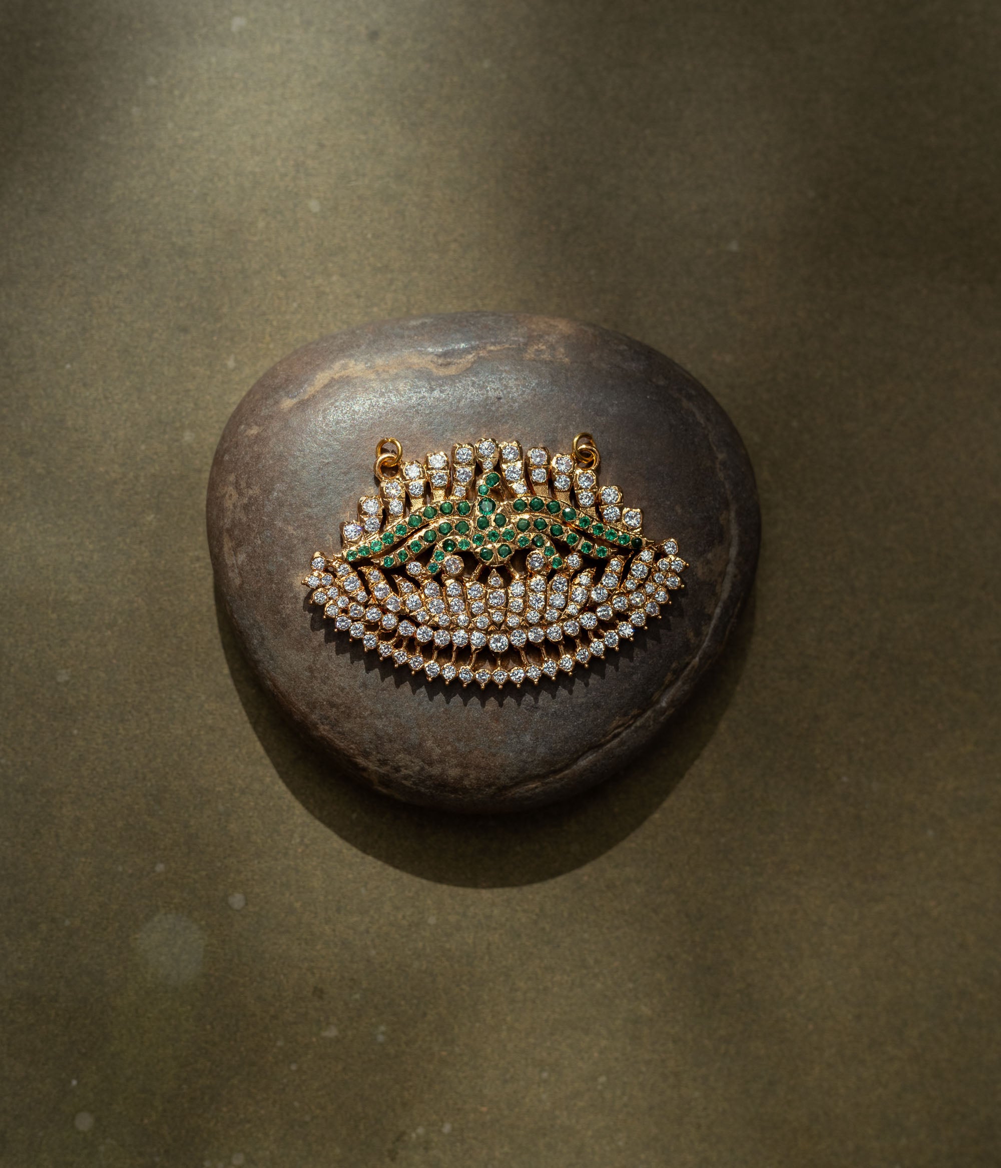 Gold pendant with CZ and green stones in feathered wing shape from the Stone Collection.
