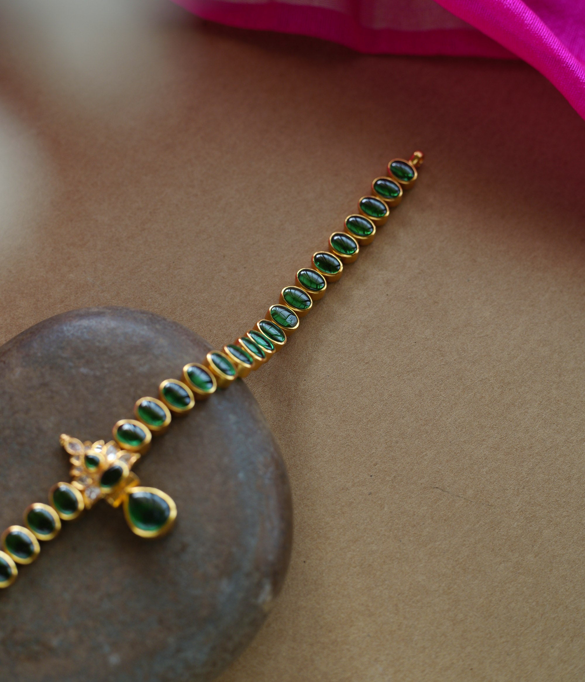 Elegant green stone necklace with center design from Navratna Collection, featuring Swarovski detailing.