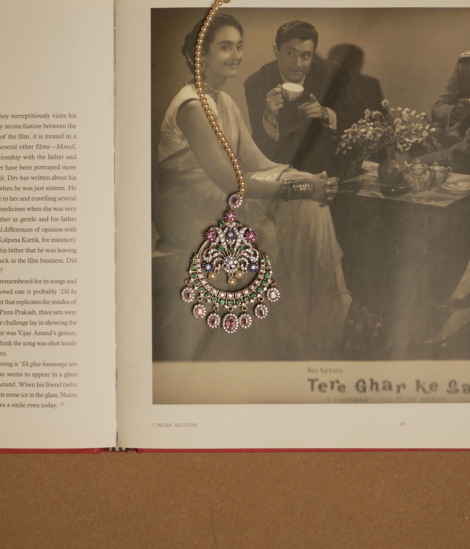 Traditional tikka with Swarovski stones, pink Kundan, and pearl drops in a floral crescent design.