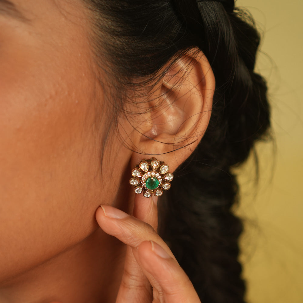 A timeless bloom! This stud earring features a radiant green spinel center, encircled by shimmering Polki and CZ stones. A delicate symbol of romance and fresh beginnings.