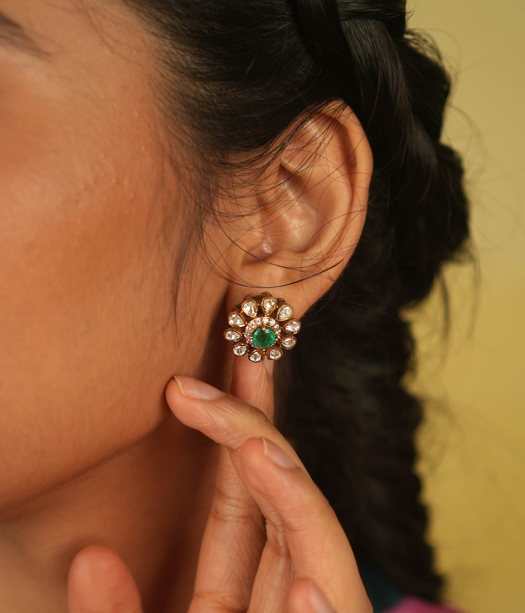 A timeless bloom! This stud earring features a radiant green spinel center, encircled by shimmering Polki and CZ stones. A delicate symbol of romance and fresh beginnings.