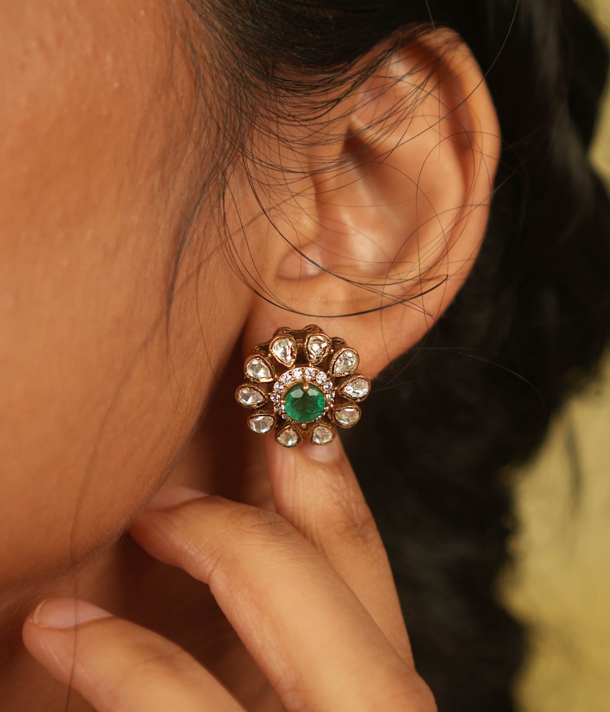 A timeless bloom! This stud earring features a radiant green spinel center, encircled by shimmering Polki and CZ stones. A delicate symbol of romance and fresh beginnings.