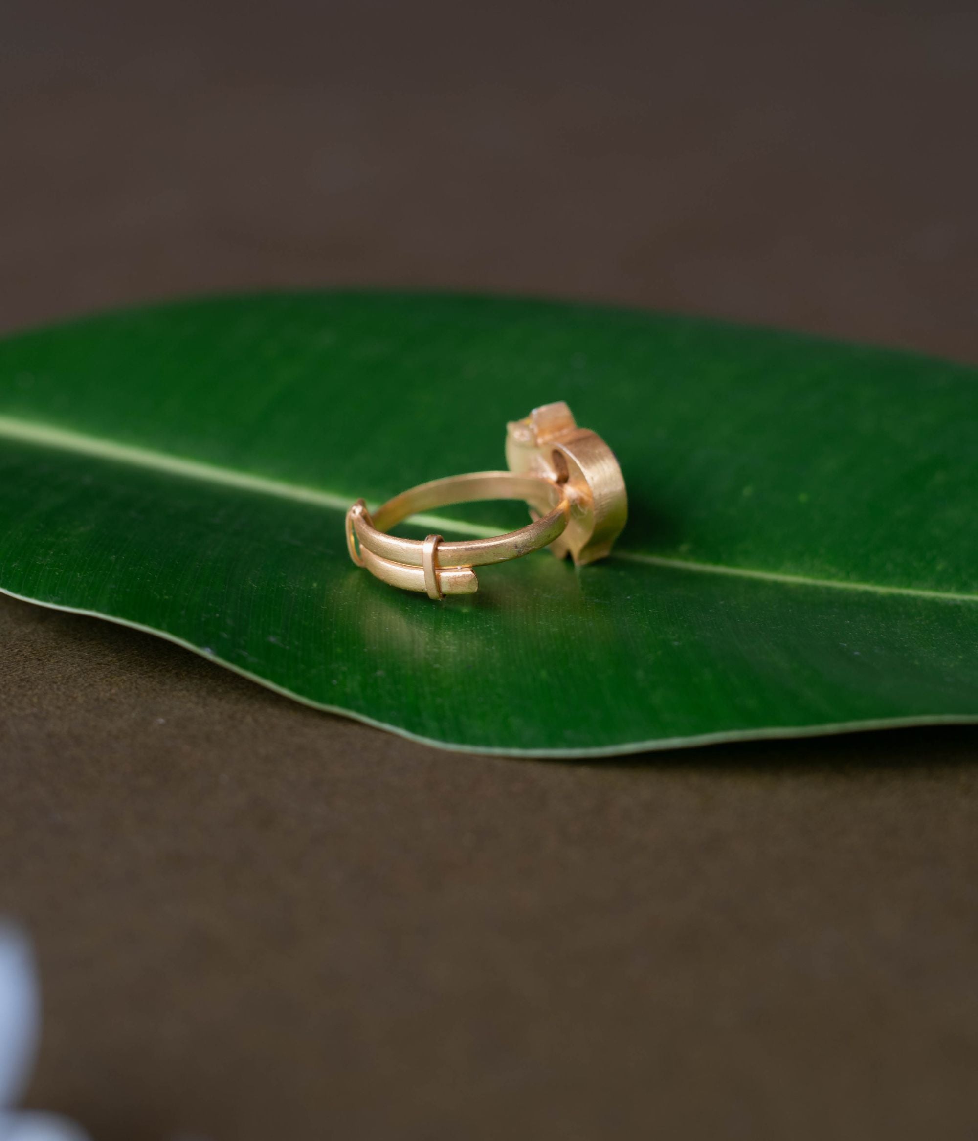 Kundan ring, Sparkling petals embrace a bird in a whisper of nature's grace.