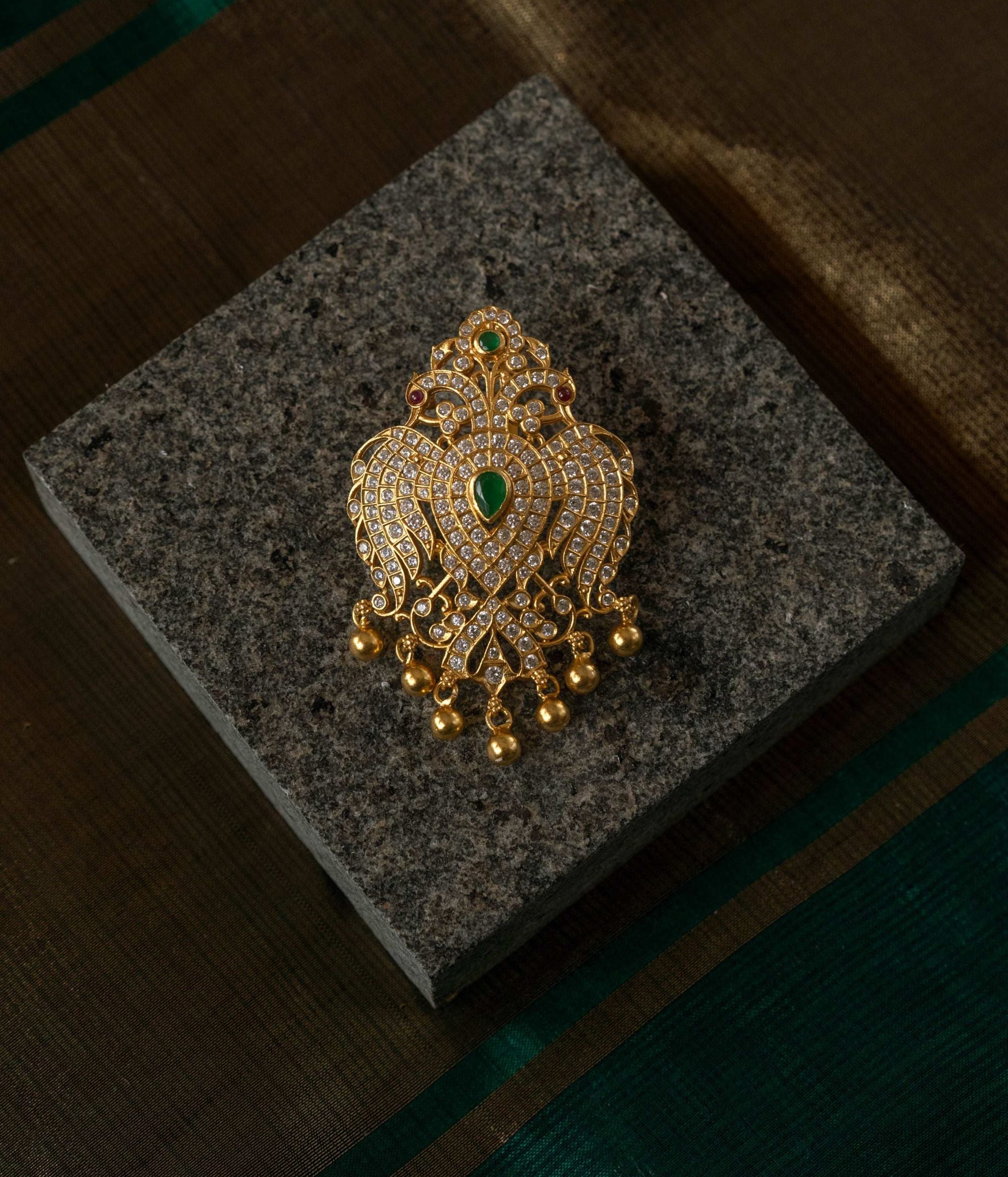 Exquisite handcrafted gold-plated peacock pendant, adorned with dazzling stones and golden beads—an elegant fusion of tradition and opulence.