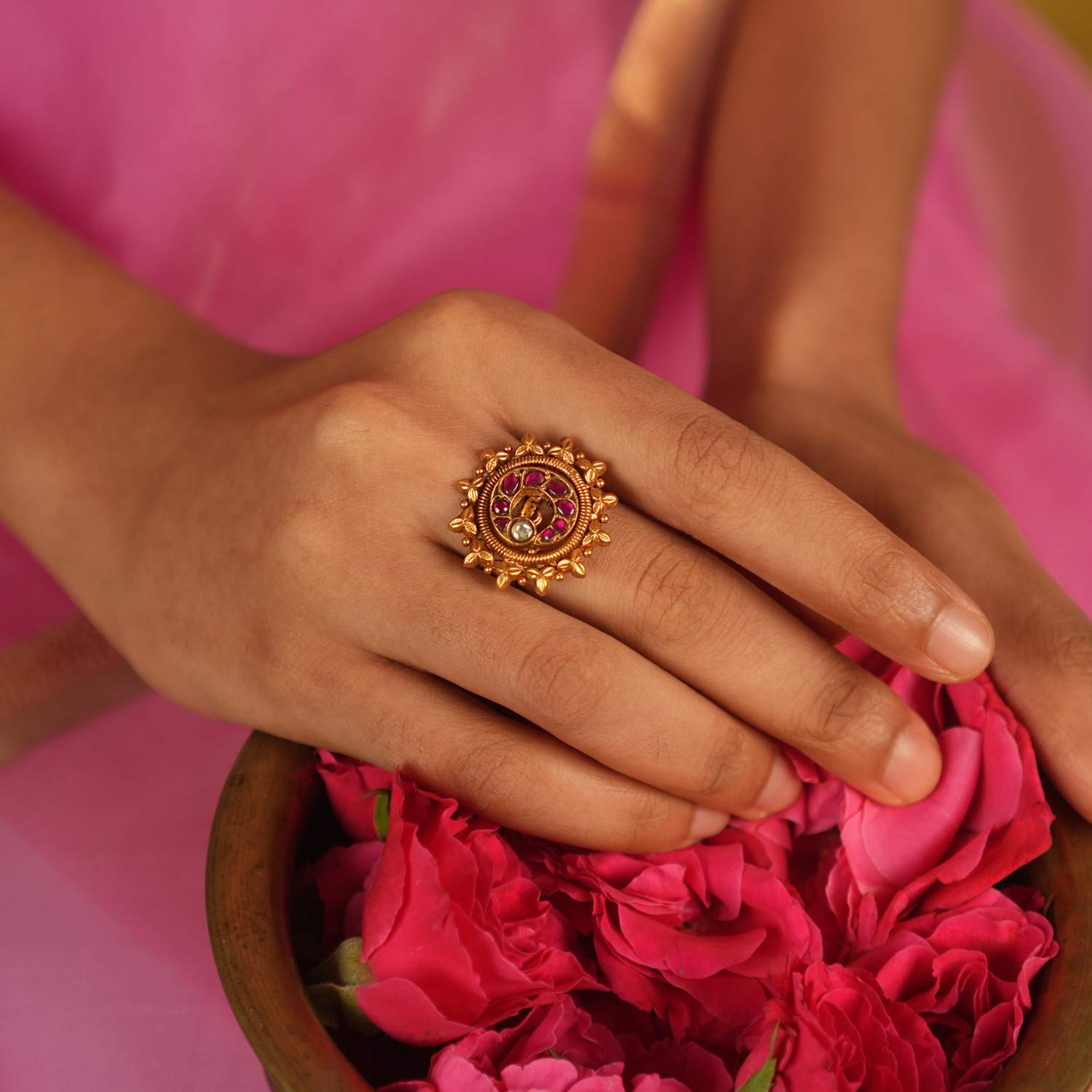 This ring, adorned with vibrant red Kundan stones set in delicate gold foil, radiates a sense of opulence and grace, making it a stunning statement piece of elegance.