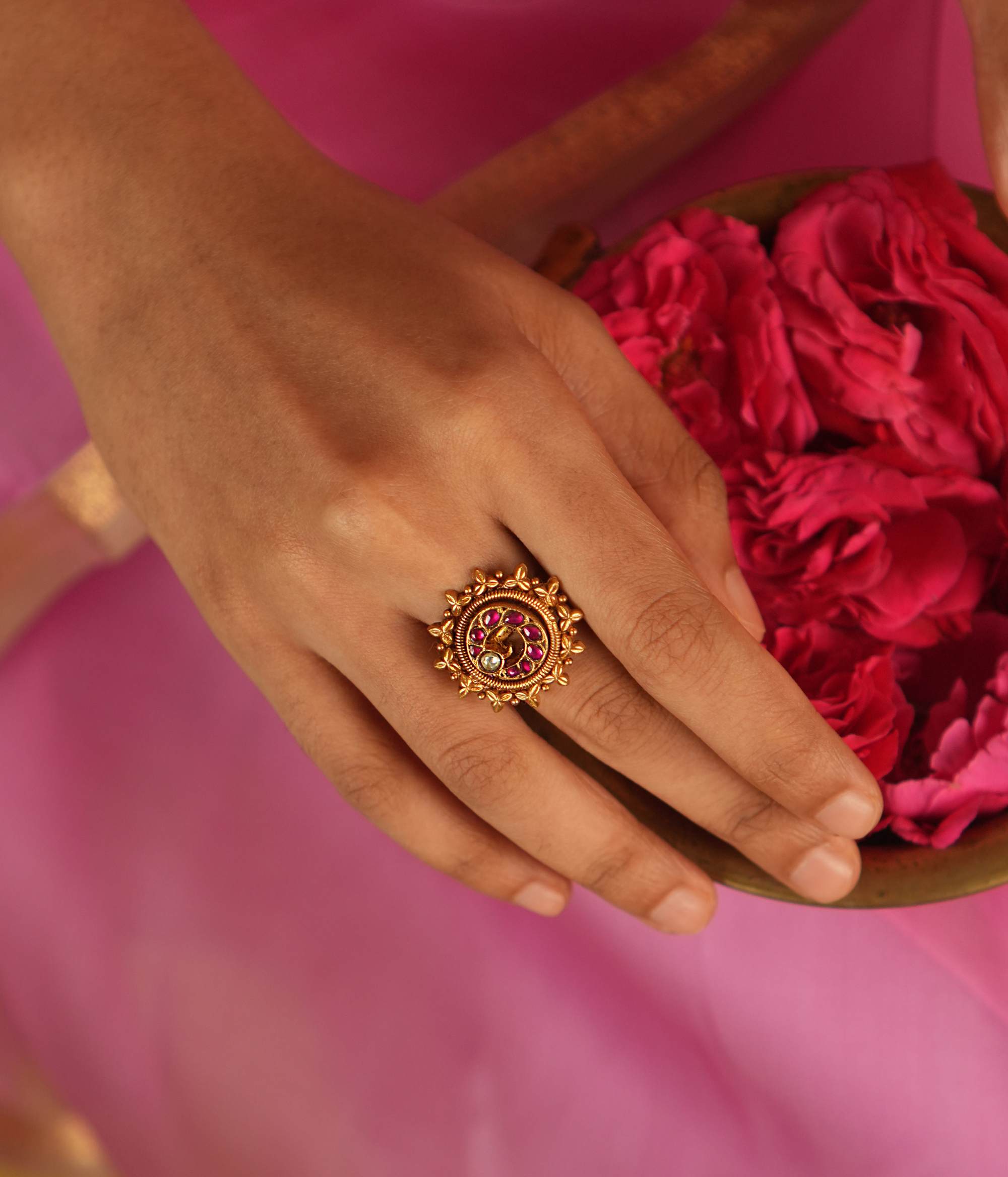 This ring, adorned with vibrant red Kundan stones set in delicate gold foil, radiates a sense of opulence and grace, making it a stunning statement piece of elegance.