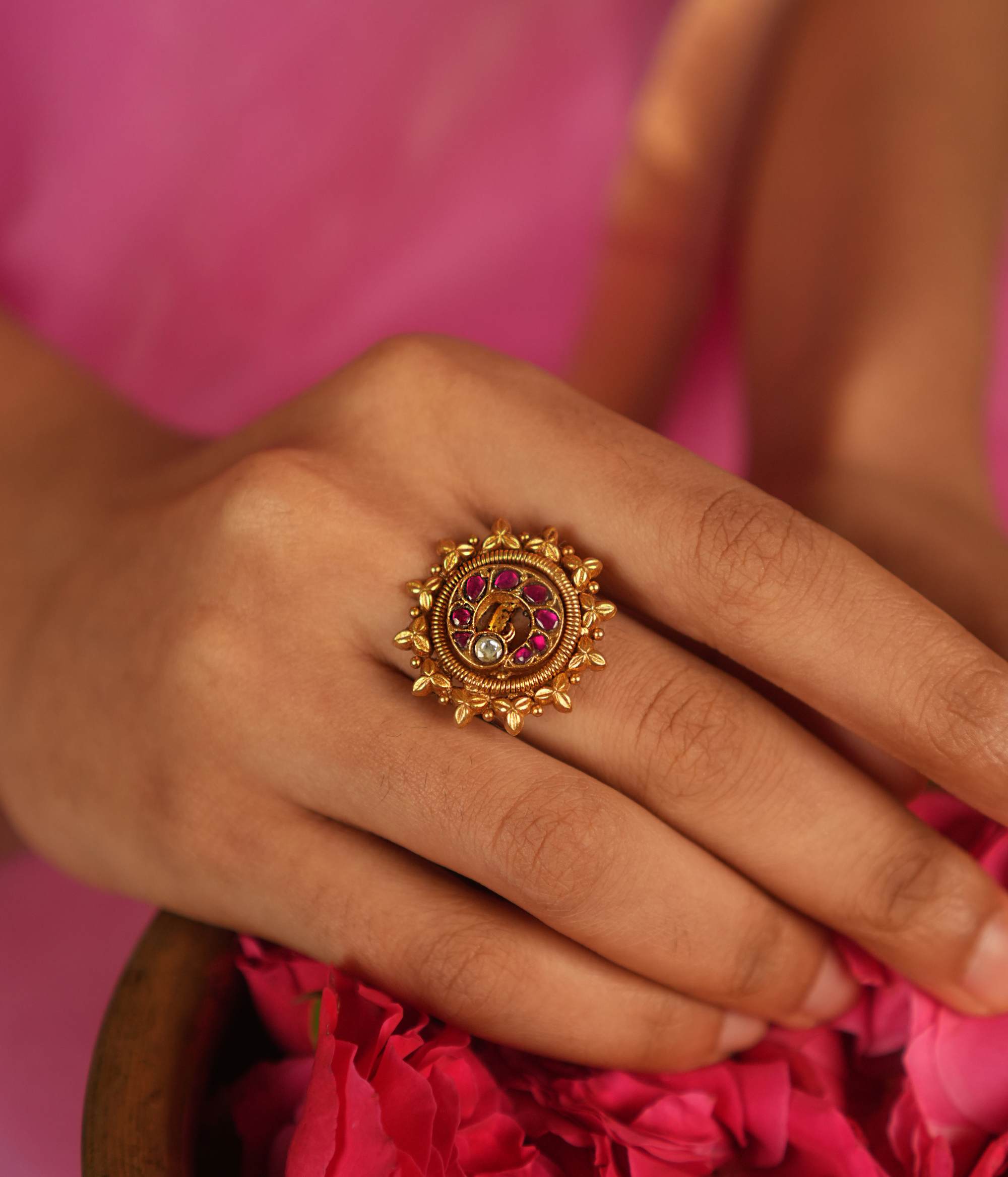 This ring, adorned with vibrant red Kundan stones set in delicate gold foil, radiates a sense of opulence and grace, making it a stunning statement piece of elegance.