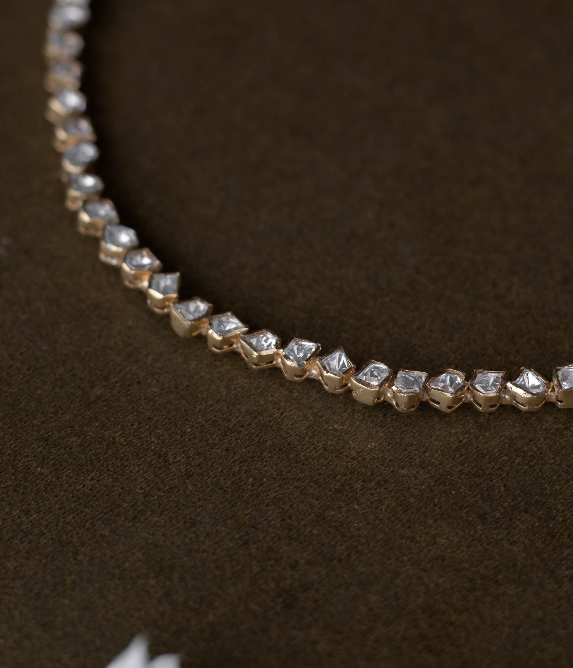 A regal masterpiece, the Savya Choker, a symphony of Polki, a timeless legacy.