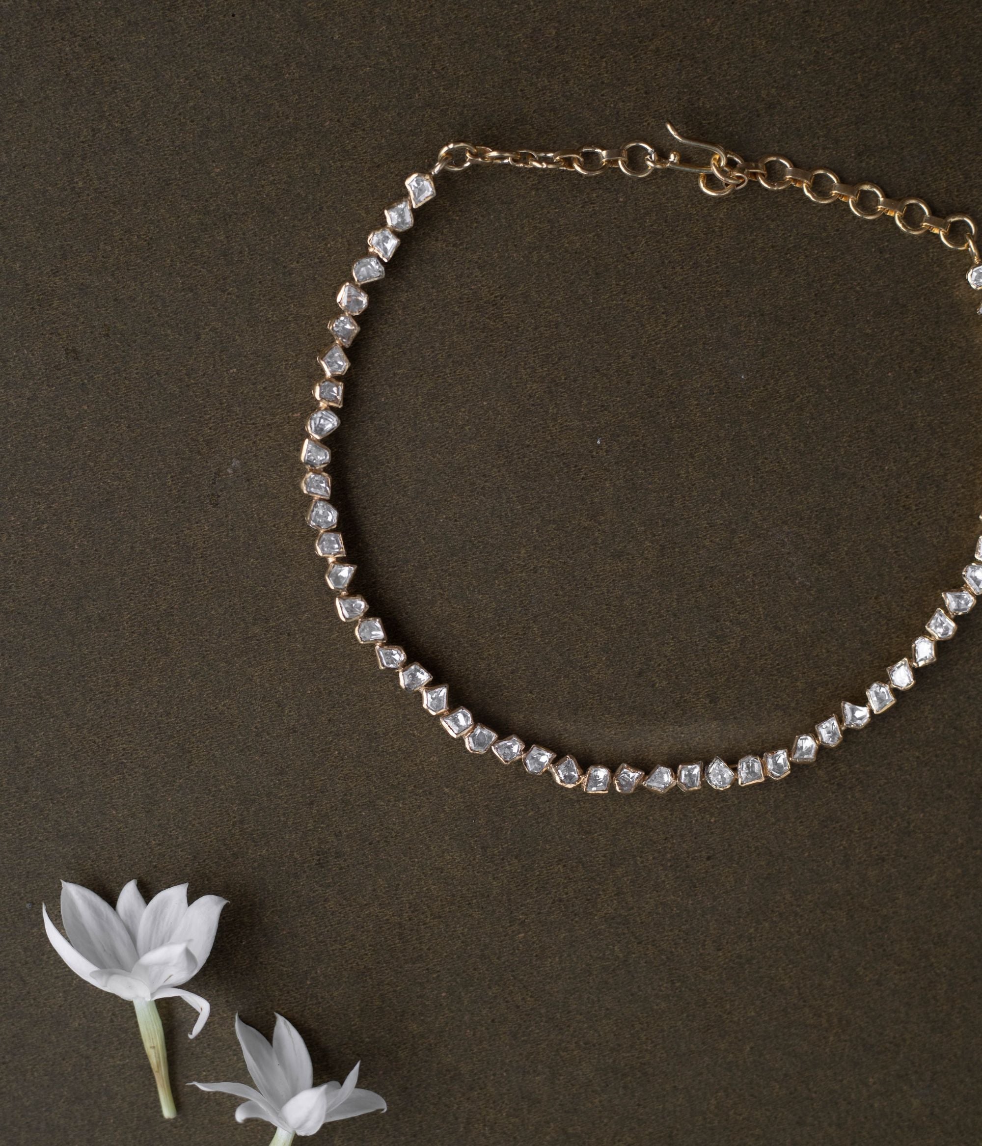 A regal masterpiece, the Savya Choker, a symphony of Polki, a timeless legacy.