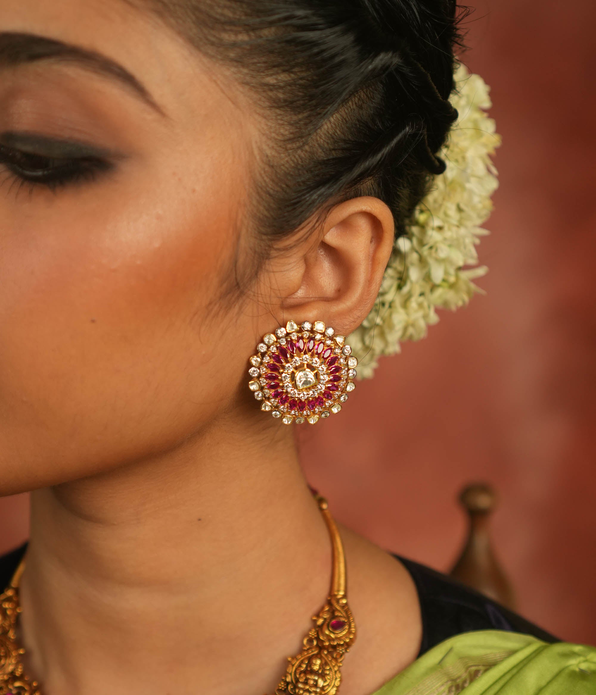 These Moissanite Polki stud earrings, adorned with CZ stones and a stunning pink tourmaline cut stone, carry the essence of Victorian elegance. Each sparkle whispers romance, making these earrings a timeless treasure that echoes the charm of a bygone era.