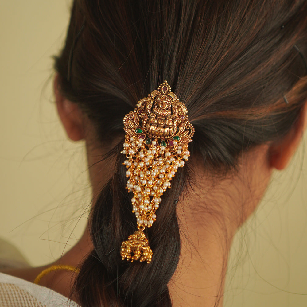 Shaila Hairpin: A touch of temple elegance. Gold-plated silver adorned with pearls, red and green spinels, and a delicate jhumki—an Aaranya signature.