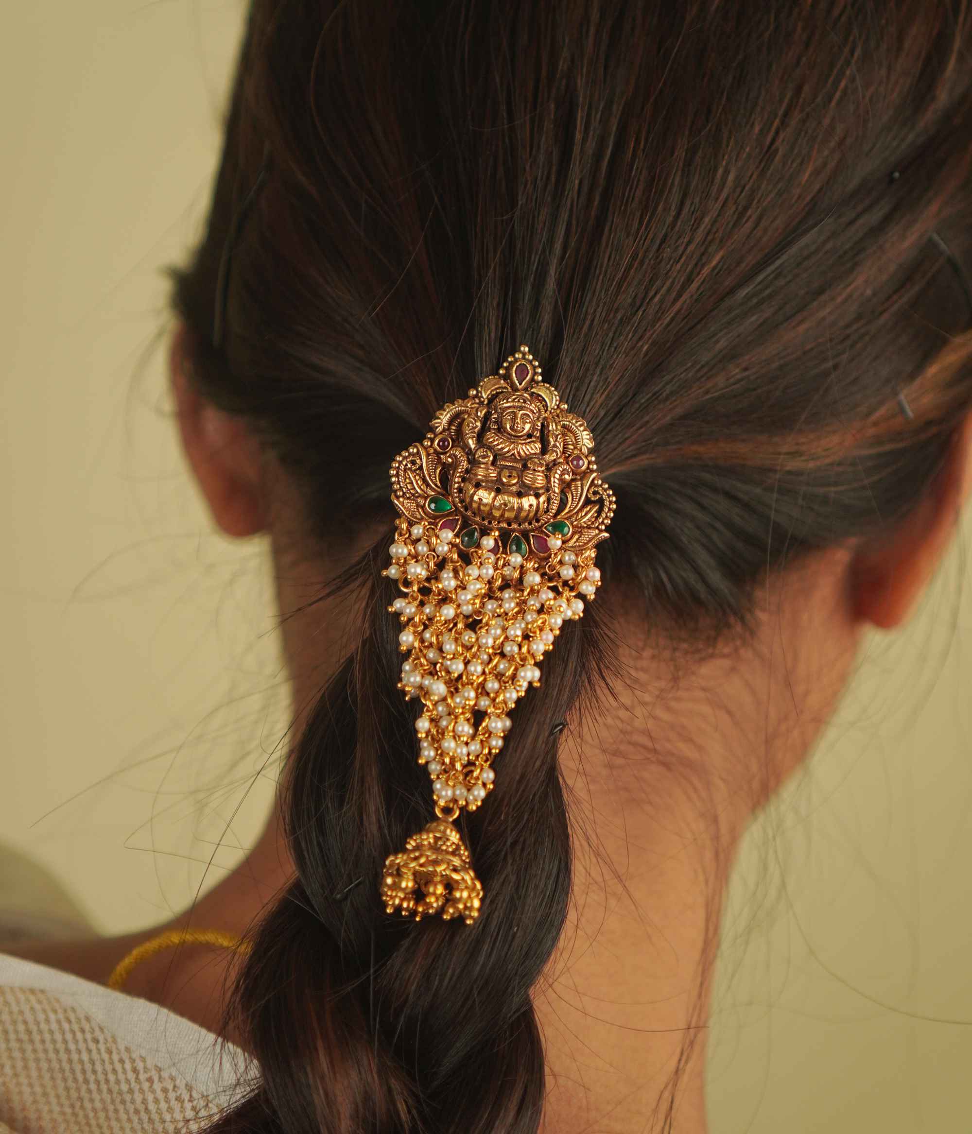 Shaila Hairpin: A touch of temple elegance. Gold-plated silver adorned with pearls, red and green spinels, and a delicate jhumki—an Aaranya signature.