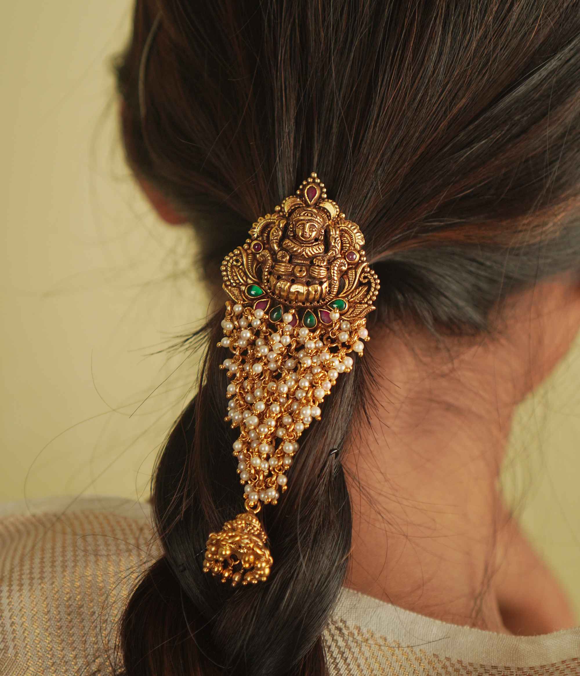 Shaila Hairpin: A touch of temple elegance. Gold-plated silver adorned with pearls, red and green spinels, and a delicate jhumki—an Aaranya signature.
