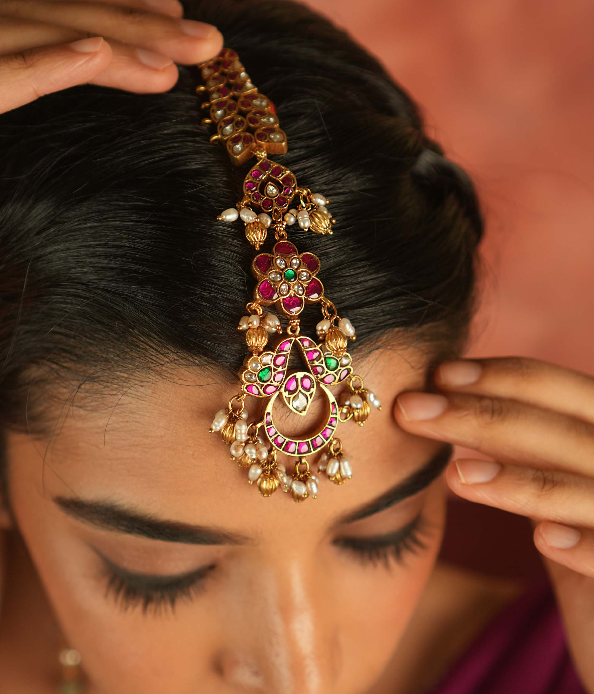 Ethereal bloom reborn! A floral Kundan maangtika adorned with pearls and red beads, where celestial grace meets timeless splendor.