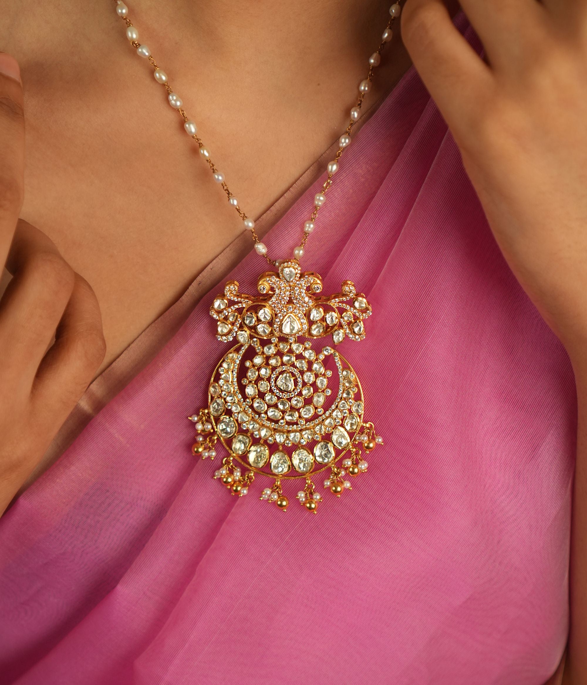 Illuminate your style with this stunning pendant, featuring Moissanite Polki stones, CZ stones, and a beautiful peacock motif. A radiant symbol of timeless elegance, it reflects exquisite craftsmanship and a rich tradition of beauty.