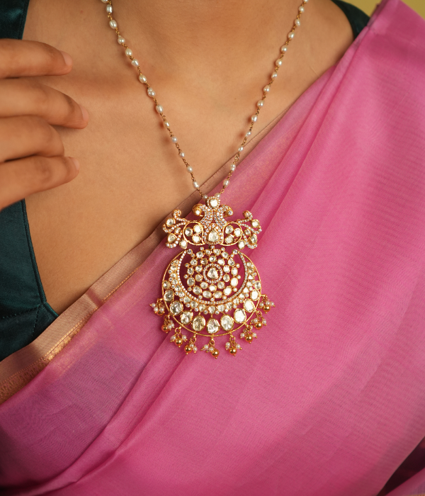 Illuminate your style with this stunning pendant, featuring Moissanite Polki stones, CZ stones, and a beautiful peacock motif. A radiant symbol of timeless elegance, it reflects exquisite craftsmanship and a rich tradition of beauty.