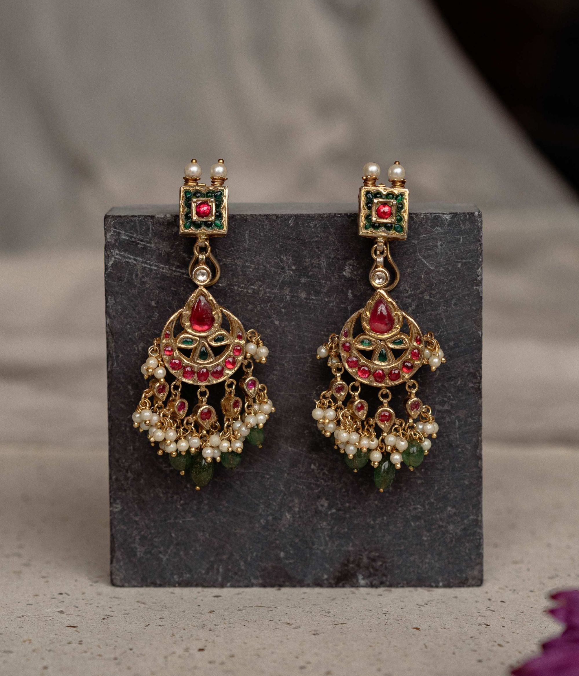 Embrace royal elegance with these enchanting Chandbali earrings, where vibrant gemstones and intricate engravings weave a tale of India's regal legacy.