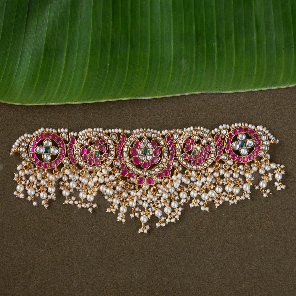 A handcrafted 92.5 sterling silver choker, featuring white, red, and green Kundan stones and pearls, showcasing intricate Kundan artistry and evoking the splendor of timeless royal elegance.