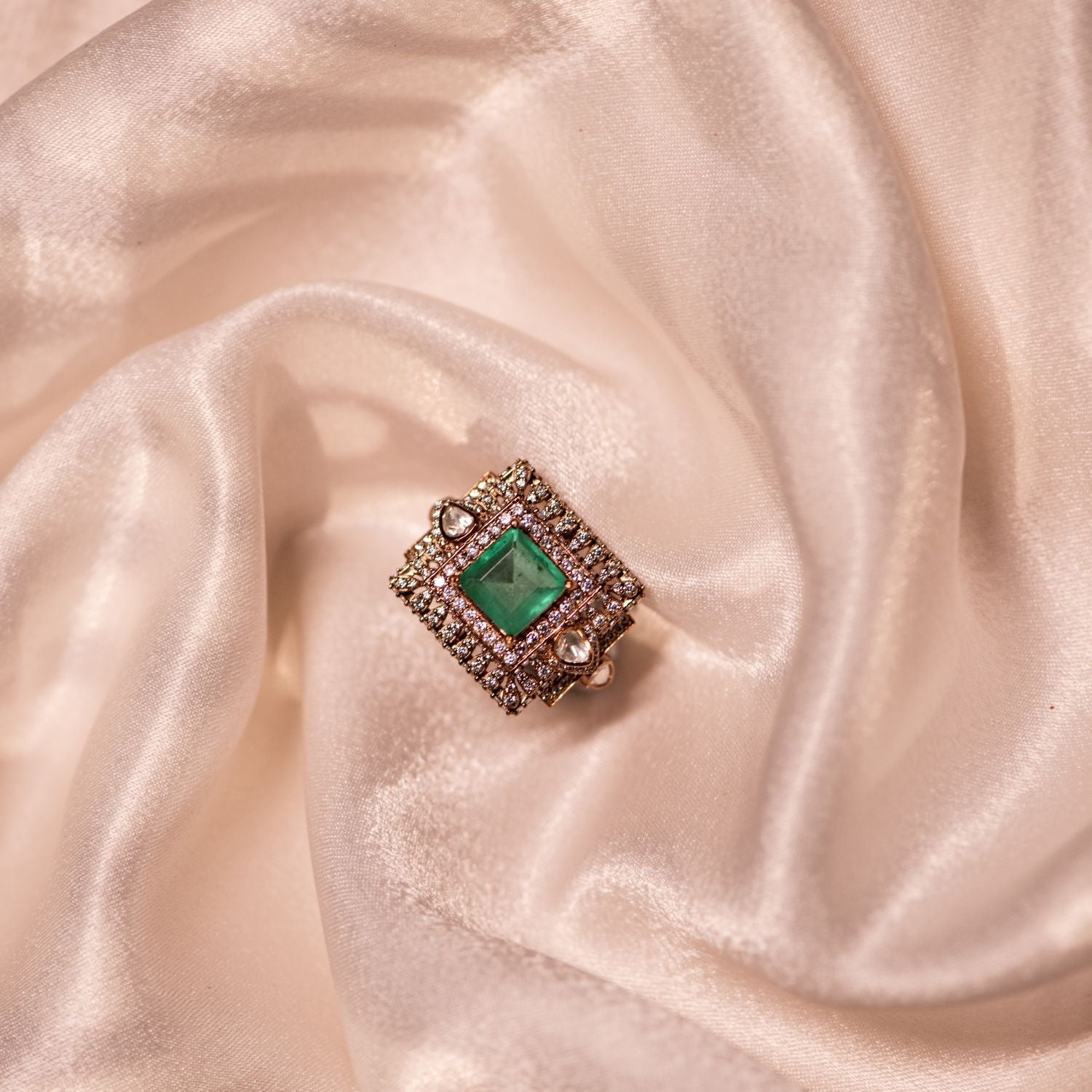 Gold-plated silver ring in an elegant square shape, adorned with dazzling Polki stones, a vibrant green gemstone, and sparkling CZ stones, creating a sophisticated and timeless design.