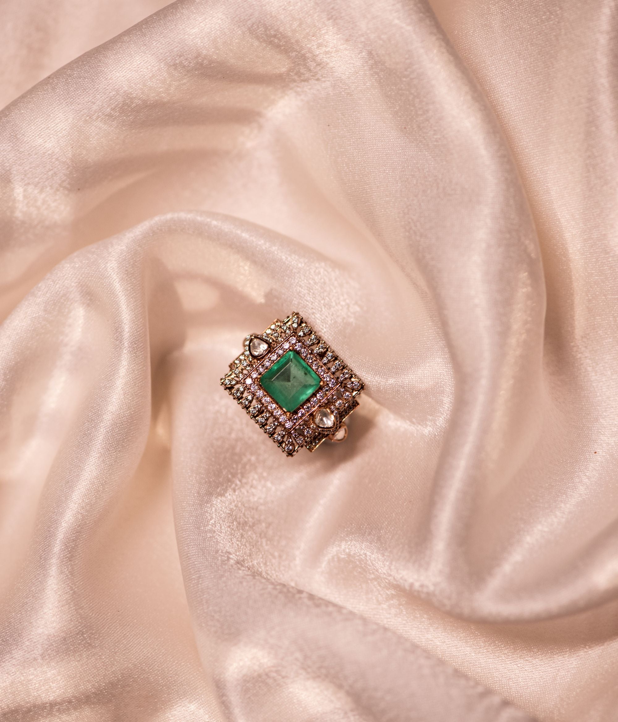 Gold-plated silver ring in an elegant square shape, adorned with dazzling Polki stones, a vibrant green gemstone, and sparkling CZ stones, creating a sophisticated and timeless design.