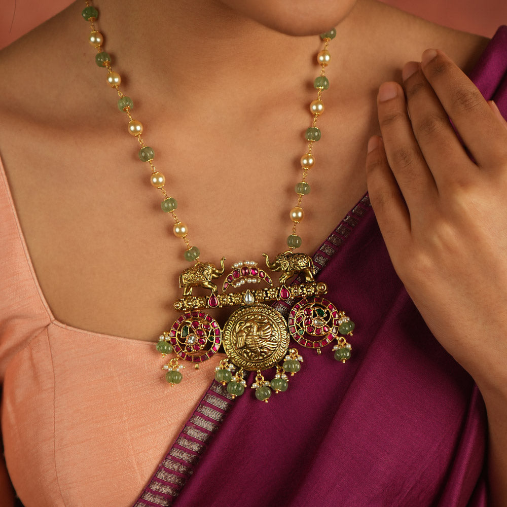 Regal menagerie reborn! Kundan necklace with peacock and elephant motifs whispers tales of opulence through vibrant hues—a timeless treasure.