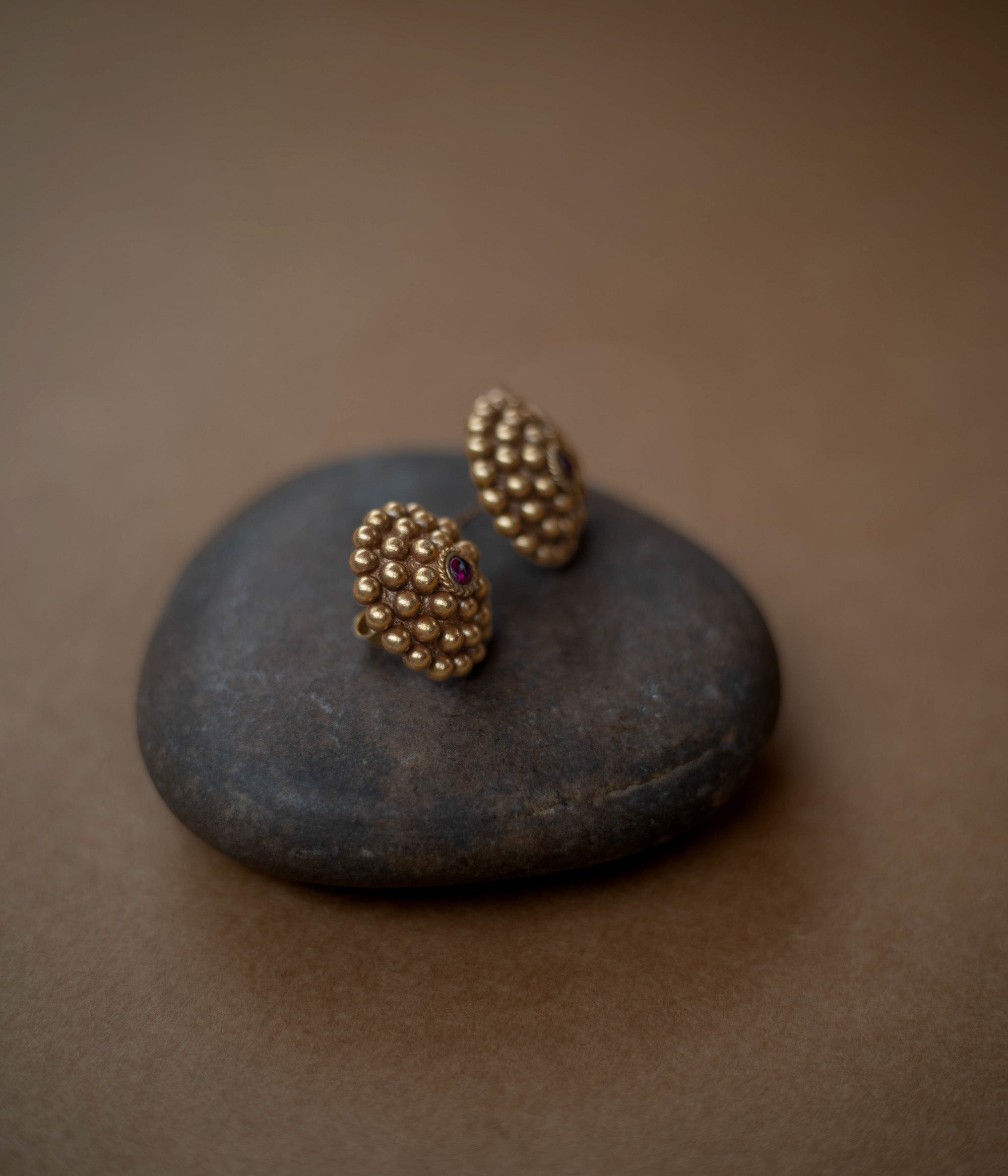 Tribal-style Rudhra earrings featuring red spinel stones, made in 92.5 sterling silver with 22ct gold plating.