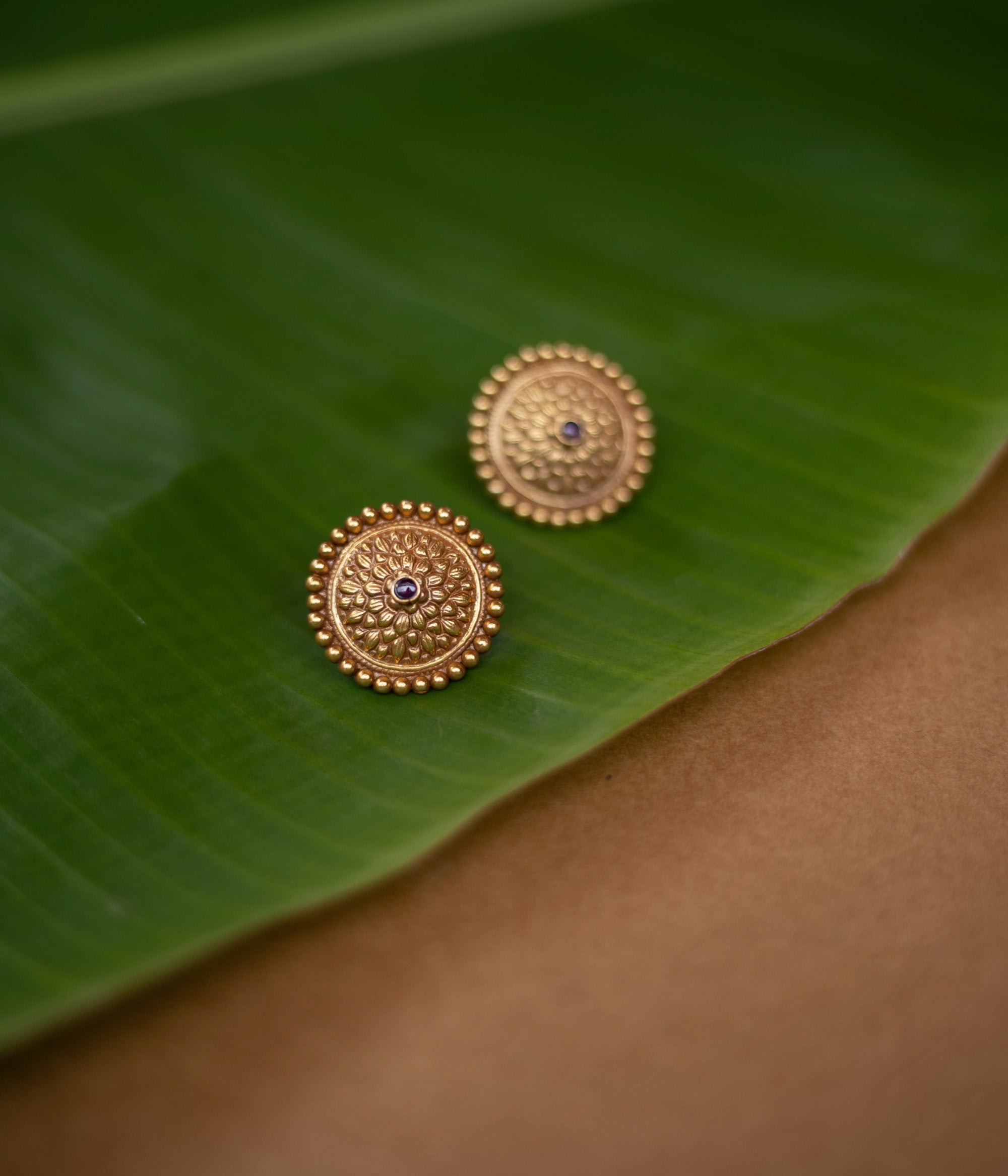 Mithra earrings with red spinel stones, tribal sunburst design in 92.5 sterling silver and 22ct gold plating.
