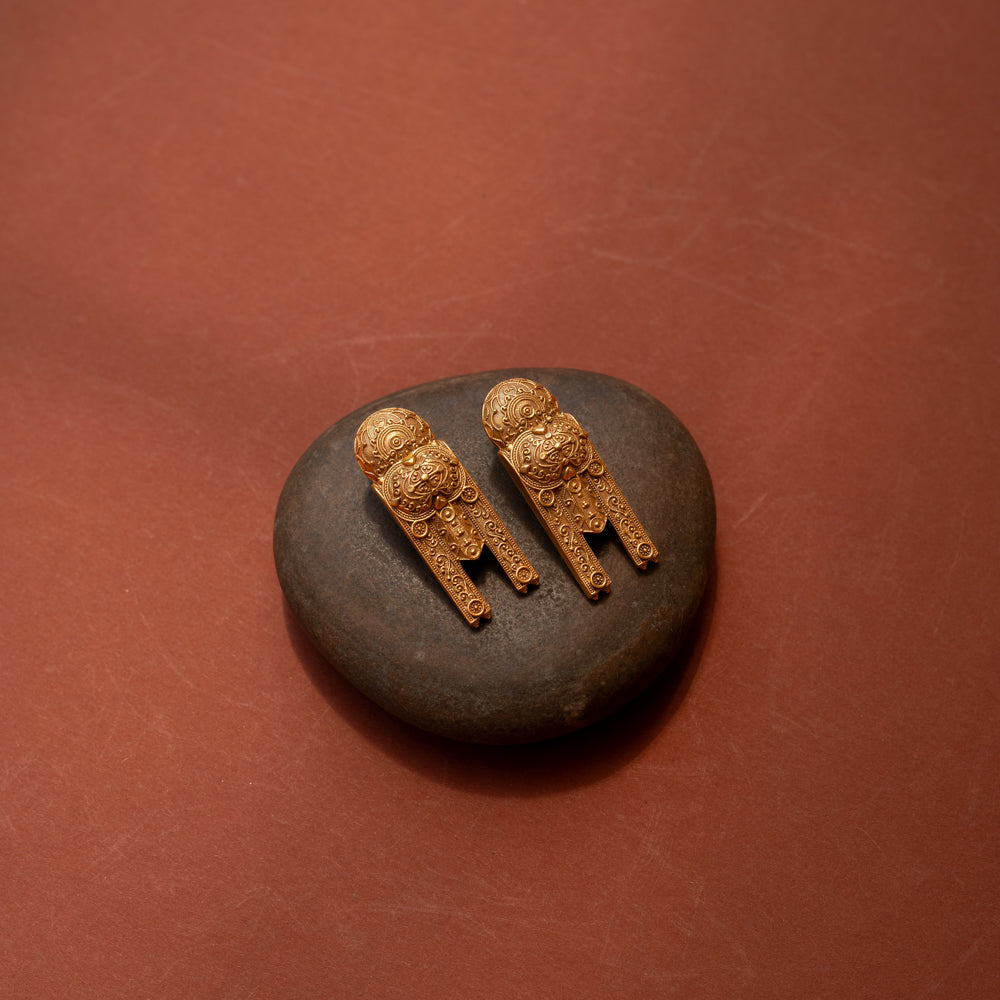 Gold tribal earrings with lion motif and yantra-inspired patterns from the Tribal Collection.