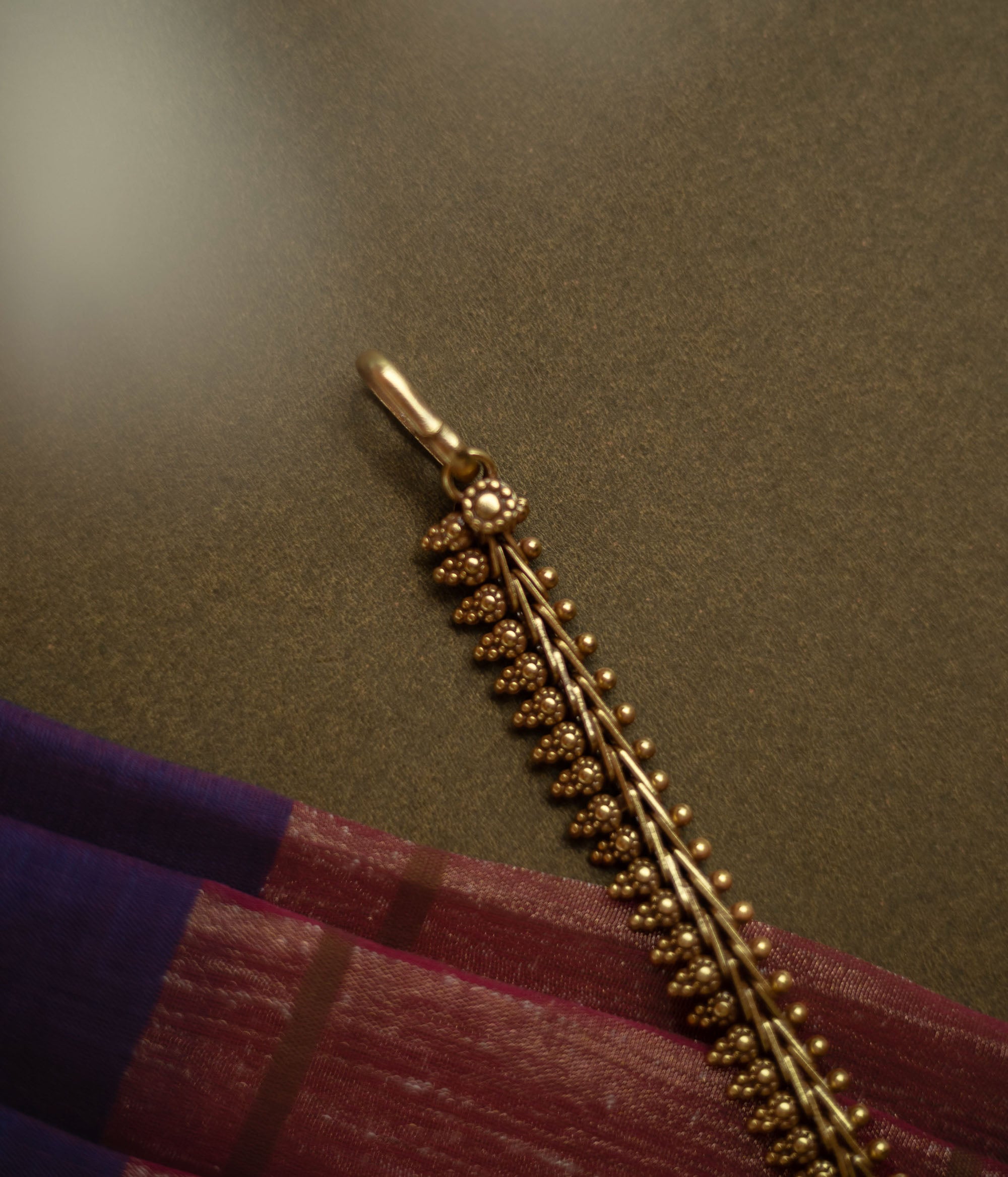 Gold-tone traditional necklace with vine and bud motifs from the Katha Collection.
