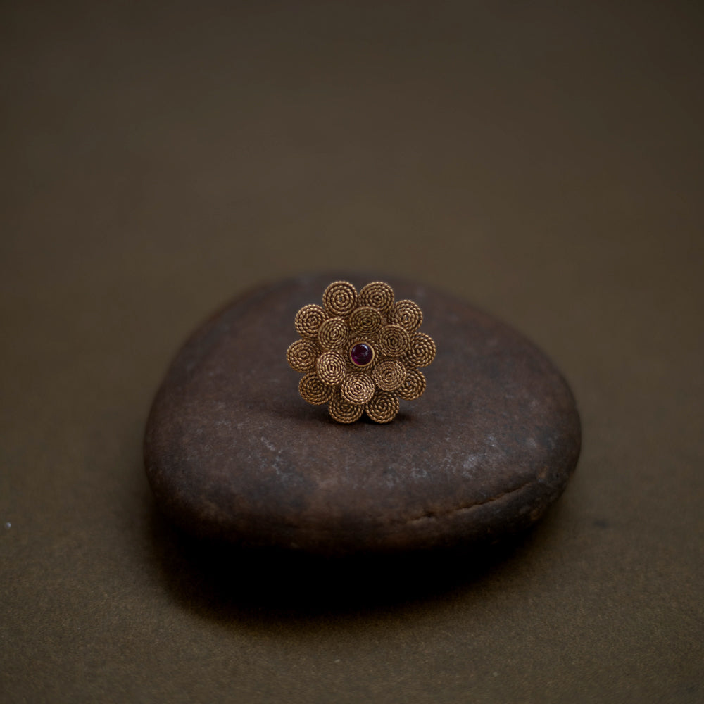 92.5 sterling silver ring with 22ct gold plating, featuring a delicate floral design centered with a radiant red spinel stone.