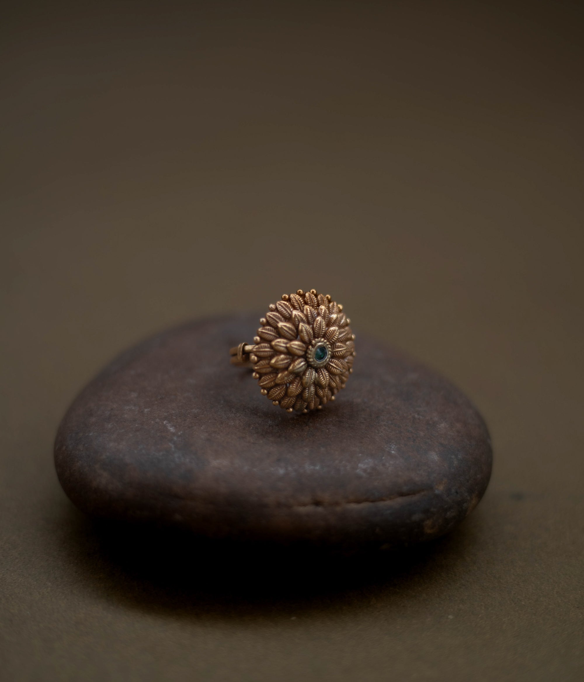 Tribal floral ring handcrafted from 92.5 sterling silver with rich 22ct gold plating, featuring a green spinel stone set in a detailed petal design.