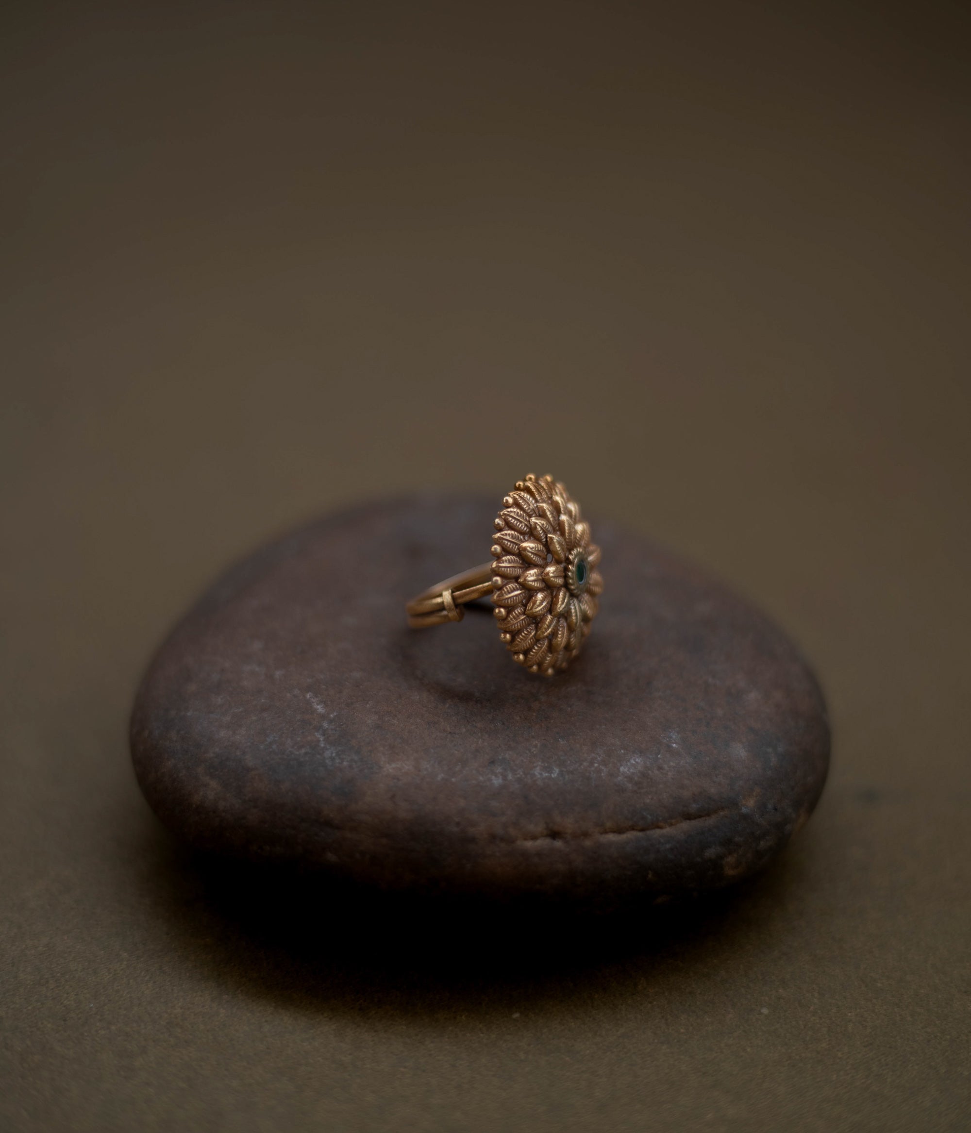 Tribal floral ring handcrafted from 92.5 sterling silver with rich 22ct gold plating, featuring a green spinel stone set in a detailed petal design.
