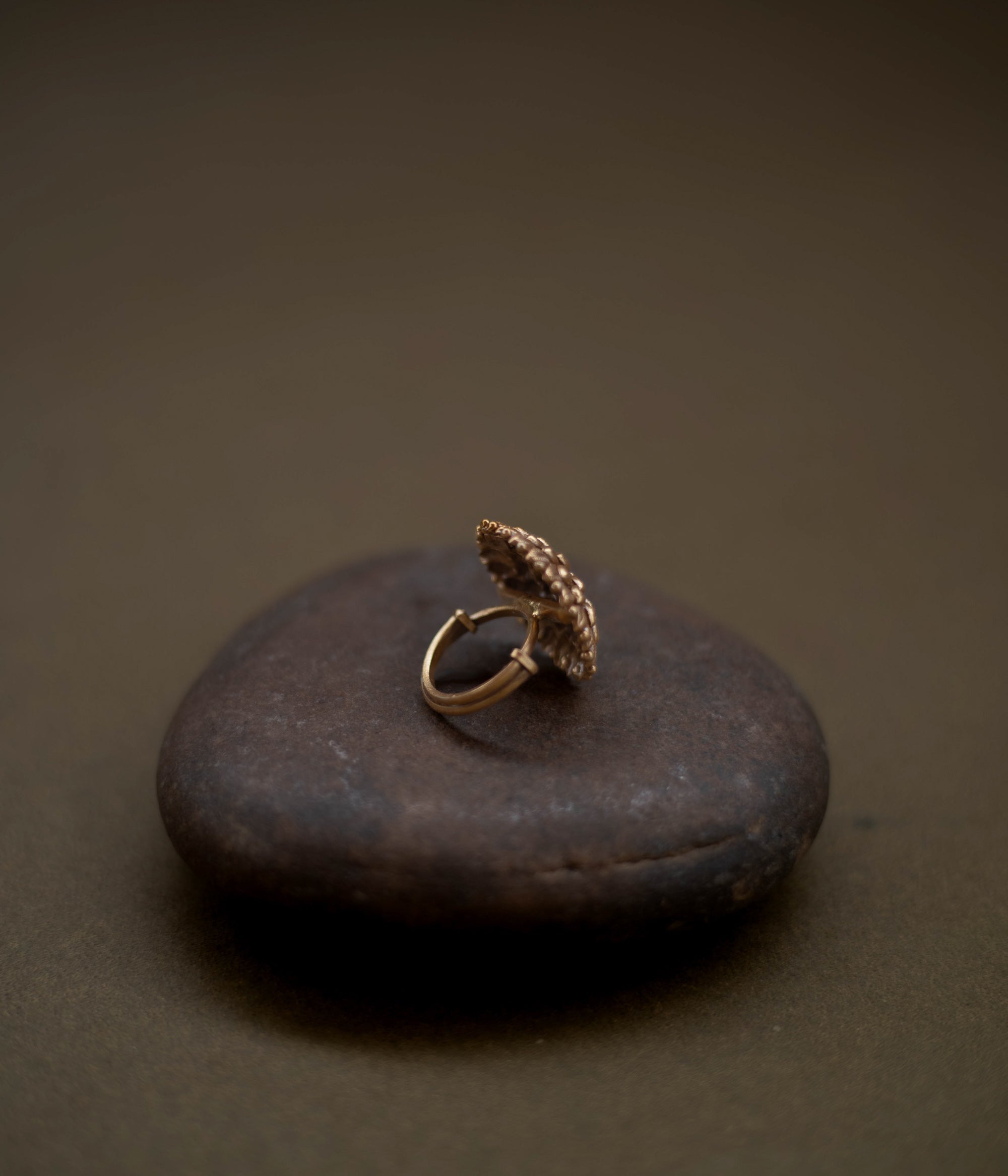 Tribal floral ring handcrafted from 92.5 sterling silver with rich 22ct gold plating, featuring a green spinel stone set in a detailed petal design.