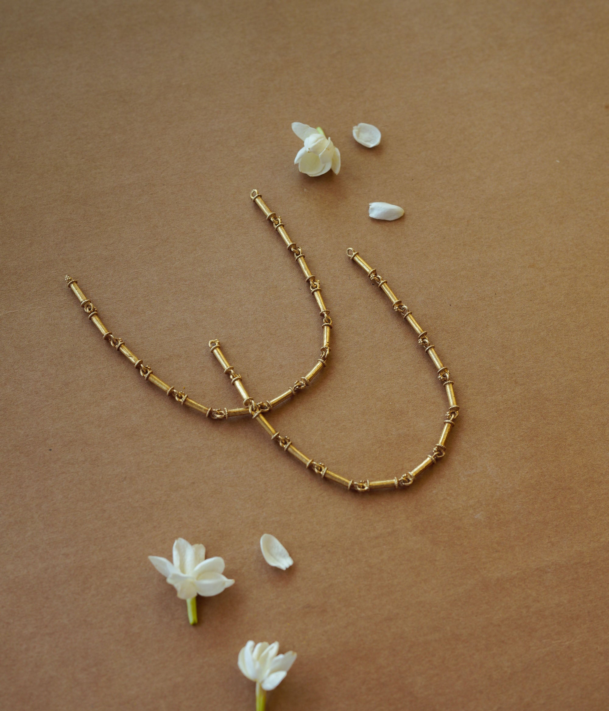 Elegant gold-toned necklace with intricate design, radiating timeless beauty and vintage-inspired charm.