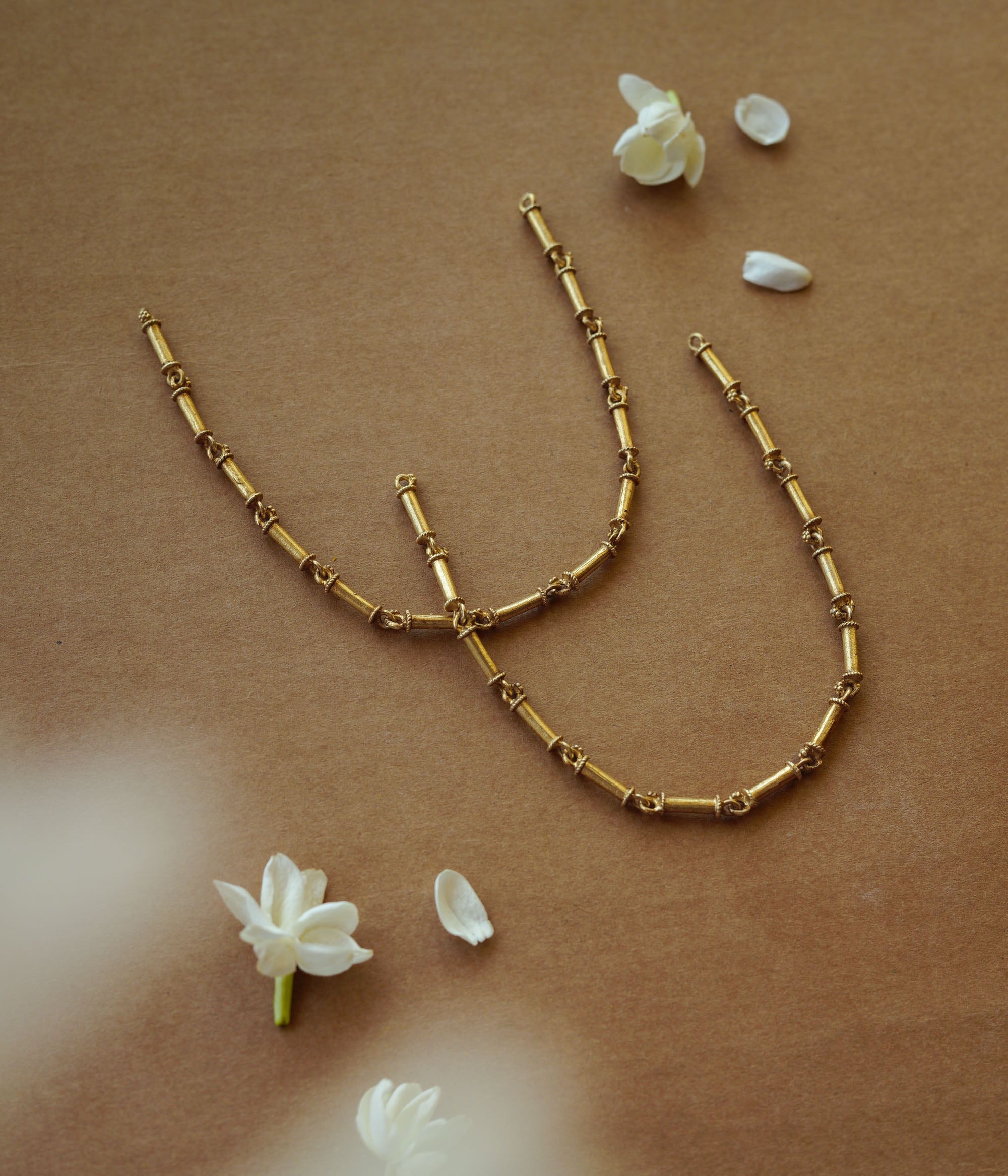 Elegant gold-toned necklace with intricate design, radiating timeless beauty and vintage-inspired charm.