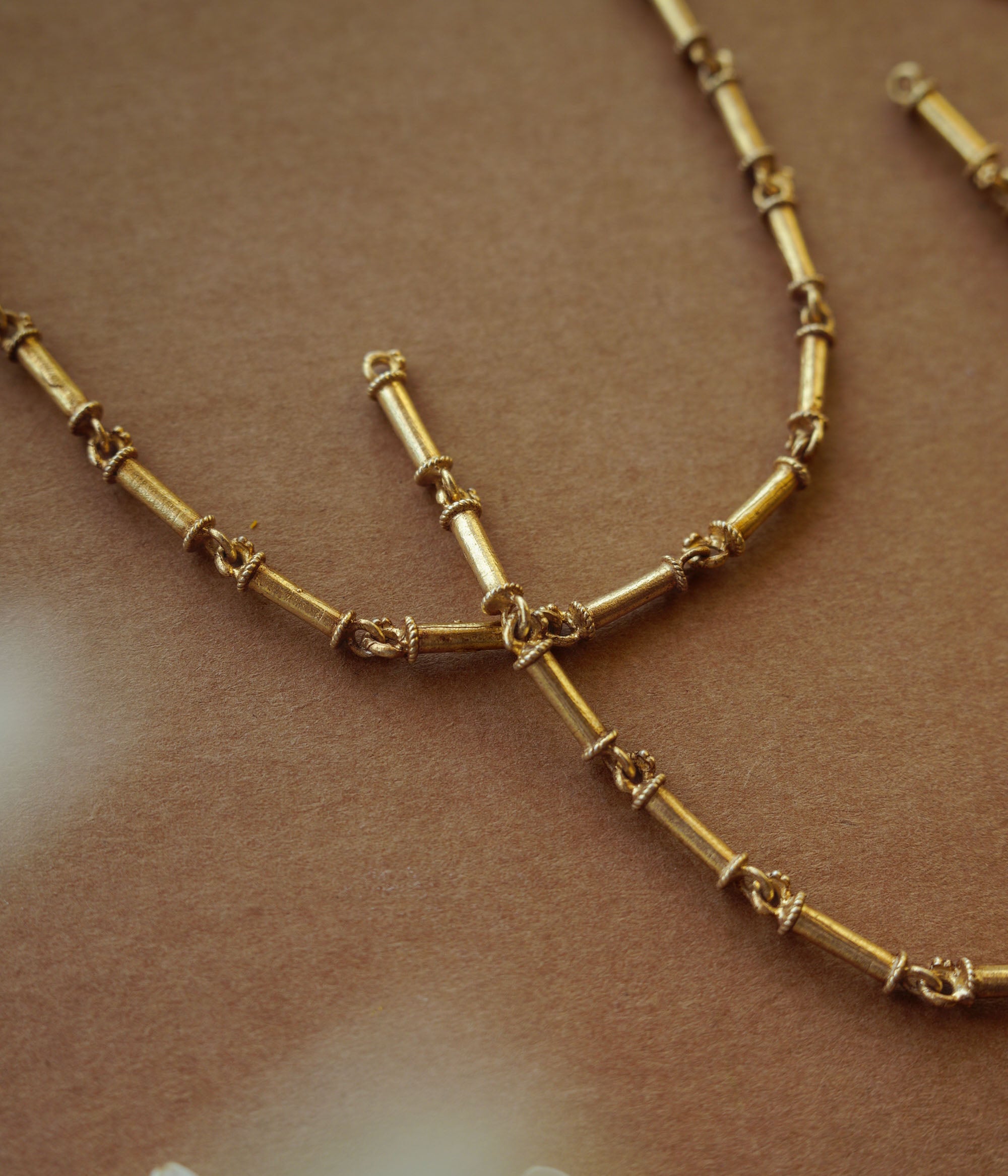 Elegant gold-toned necklace with intricate design, radiating timeless beauty and vintage-inspired charm.