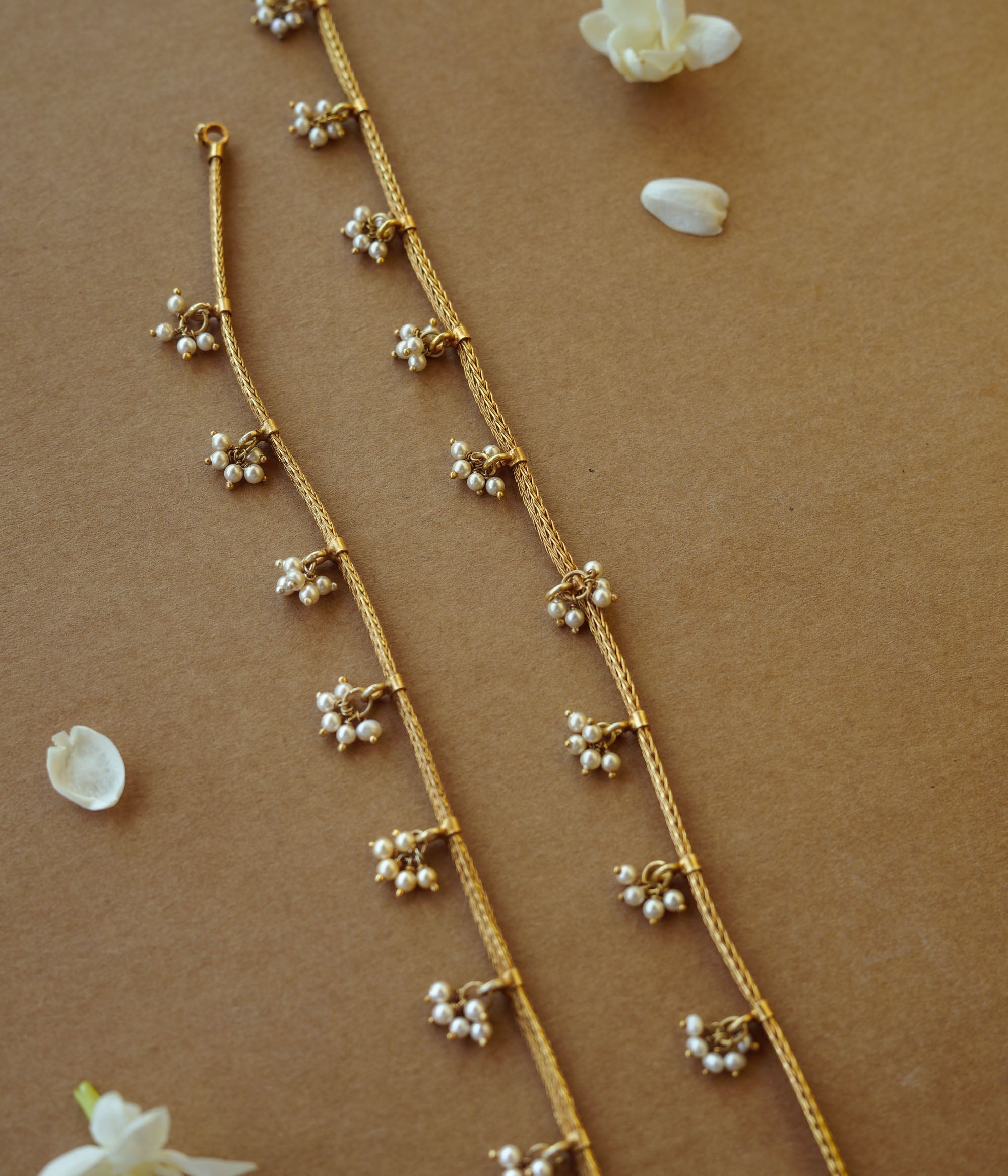 Golden tribal jasmine chain with pearl accents, nature-inspired jewelry, ethnic gold necklace design.