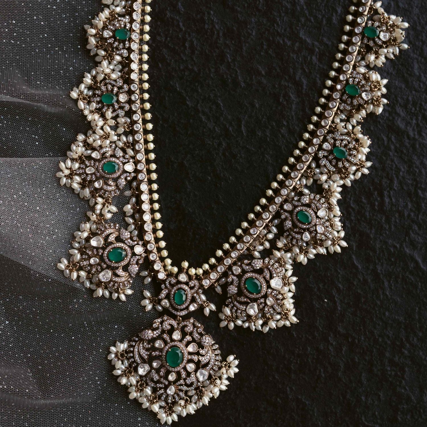 Opulent necklace adorned with Polki stones, CZ stones, duelite green stones, and white pearls, exuding timeless elegance and regal charm.