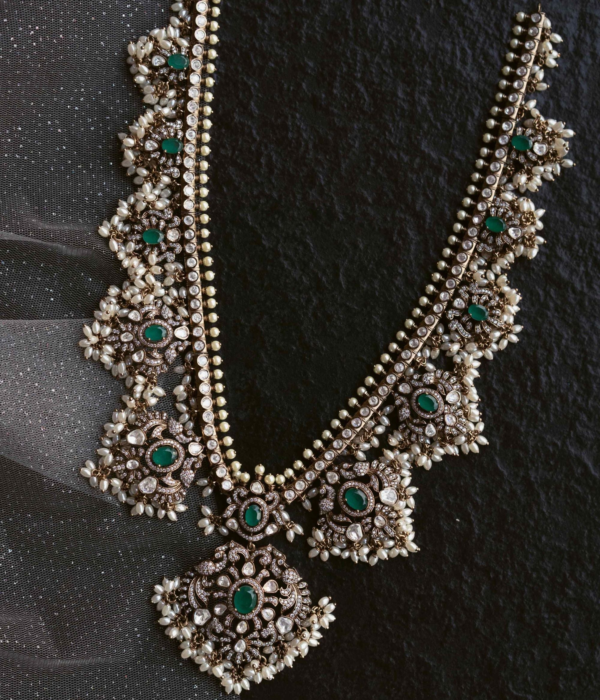 Opulent necklace adorned with Polki stones, CZ stones, duelite green stones, and white pearls, exuding timeless elegance and regal charm.