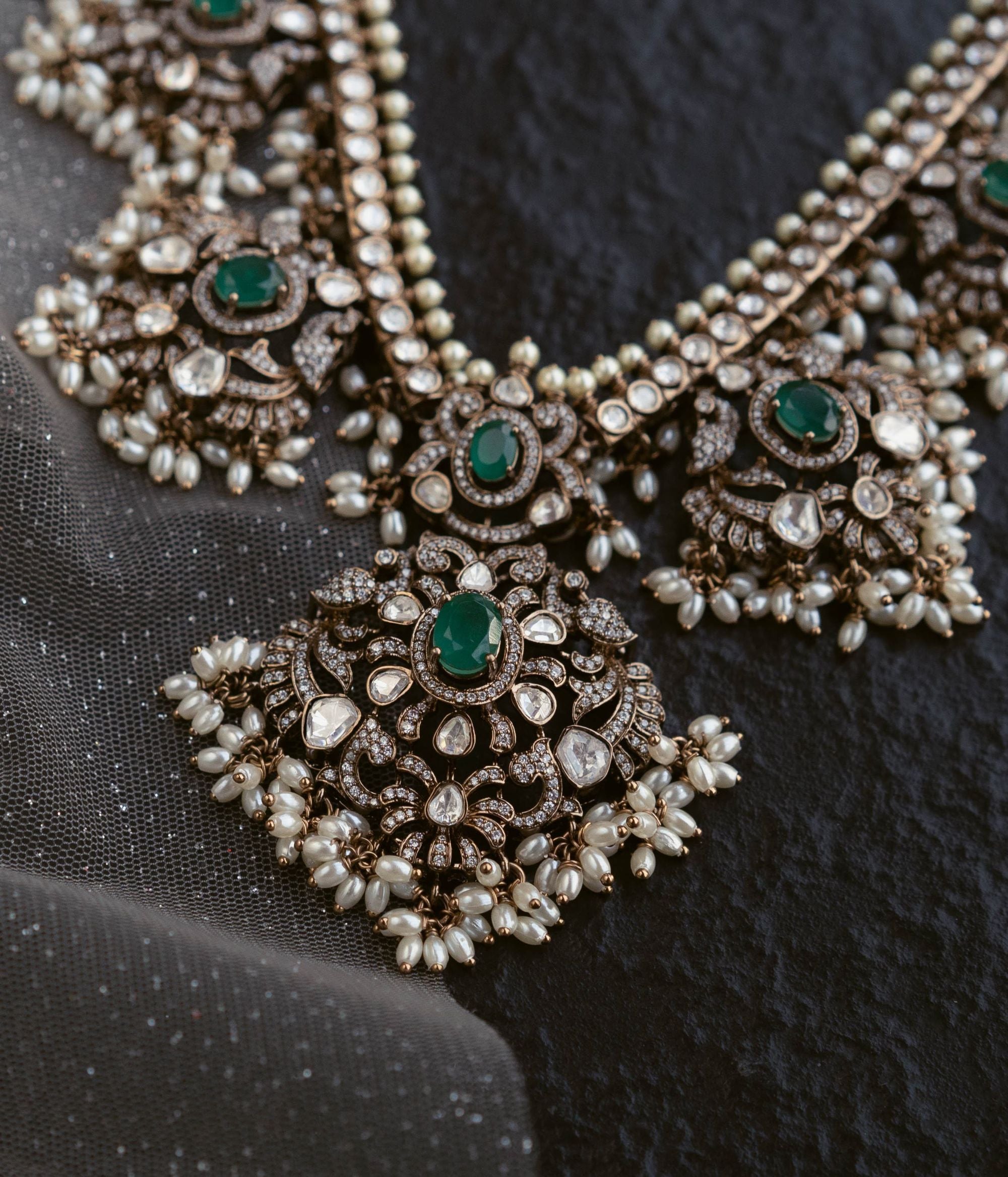 Opulent necklace adorned with Polki stones, CZ stones, duelite green stones, and white pearls, exuding timeless elegance and regal charm.