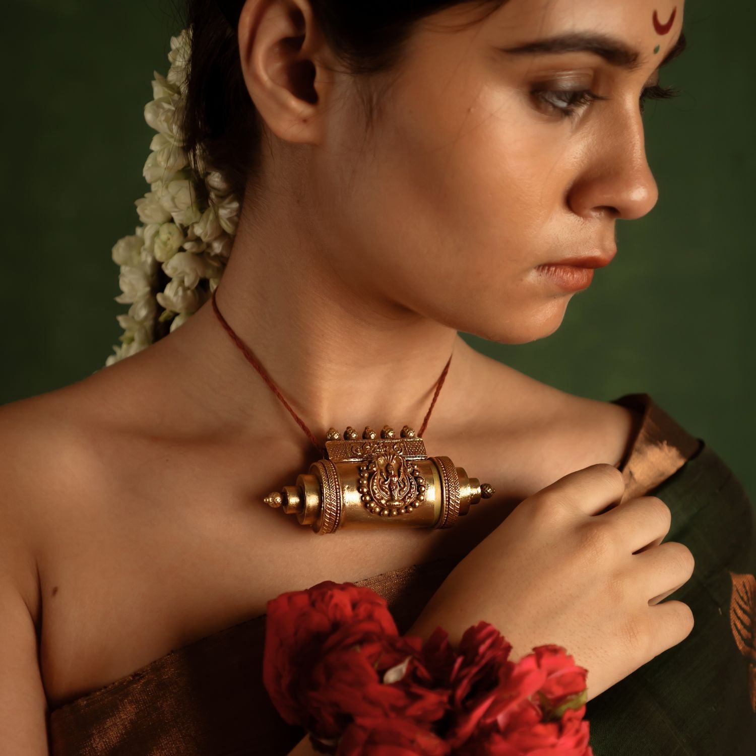 A bold statement of heritage, the Tabeez pendant with goddess motif stands as a symbol of individuality and divine grace. Crafted in gold, it commands attention with intricate deity details, celebrating Indian tradition.