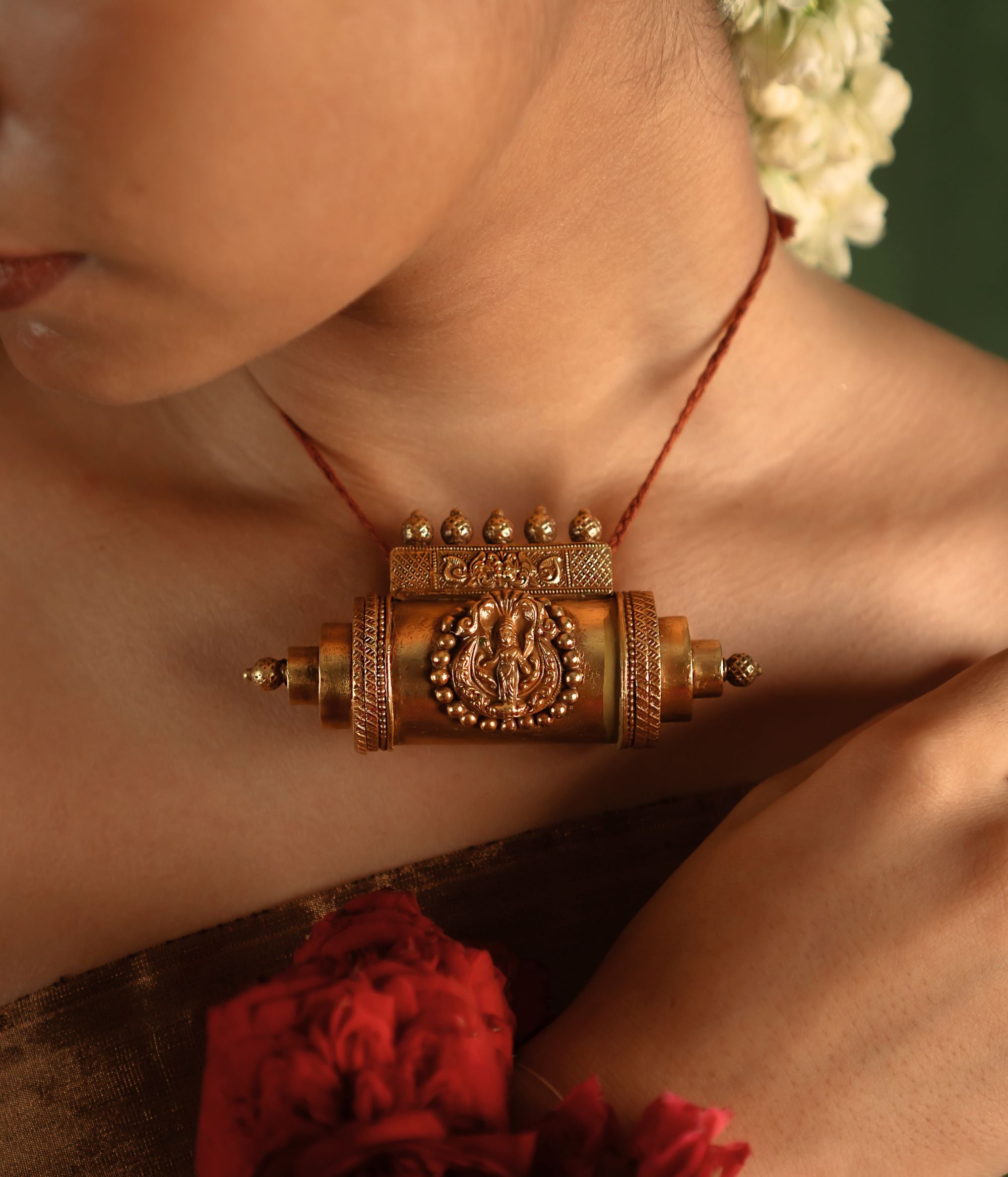 A bold statement of heritage, the Tabeez pendant with goddess motif stands as a symbol of individuality and divine grace. Crafted in gold, it commands attention with intricate deity details, celebrating Indian tradition.