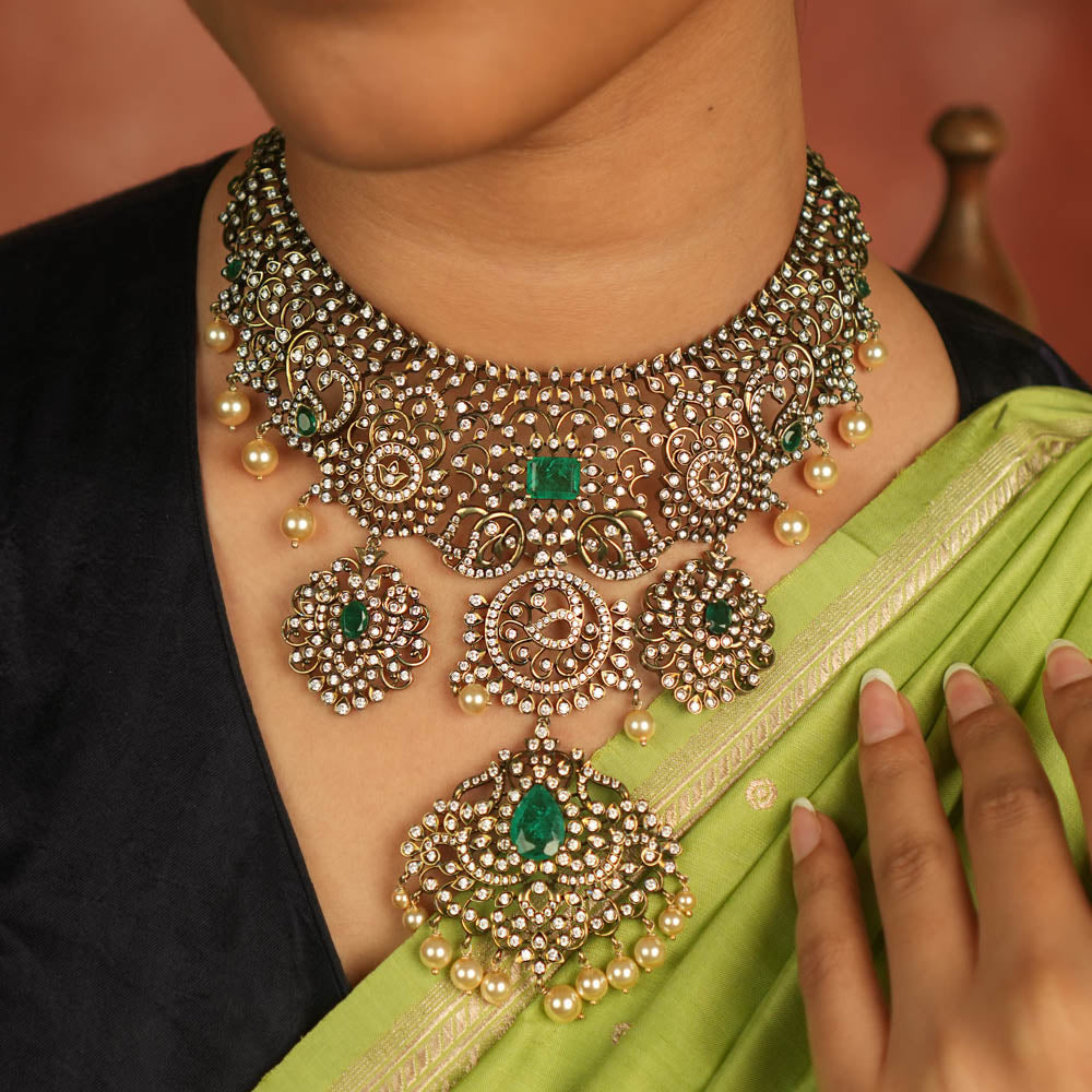 Victorian elegance reborn! This moissanite necklace with floral patterns, green-cut stones, CZ brilliance, and pearl droplets whispers timeless opulence.