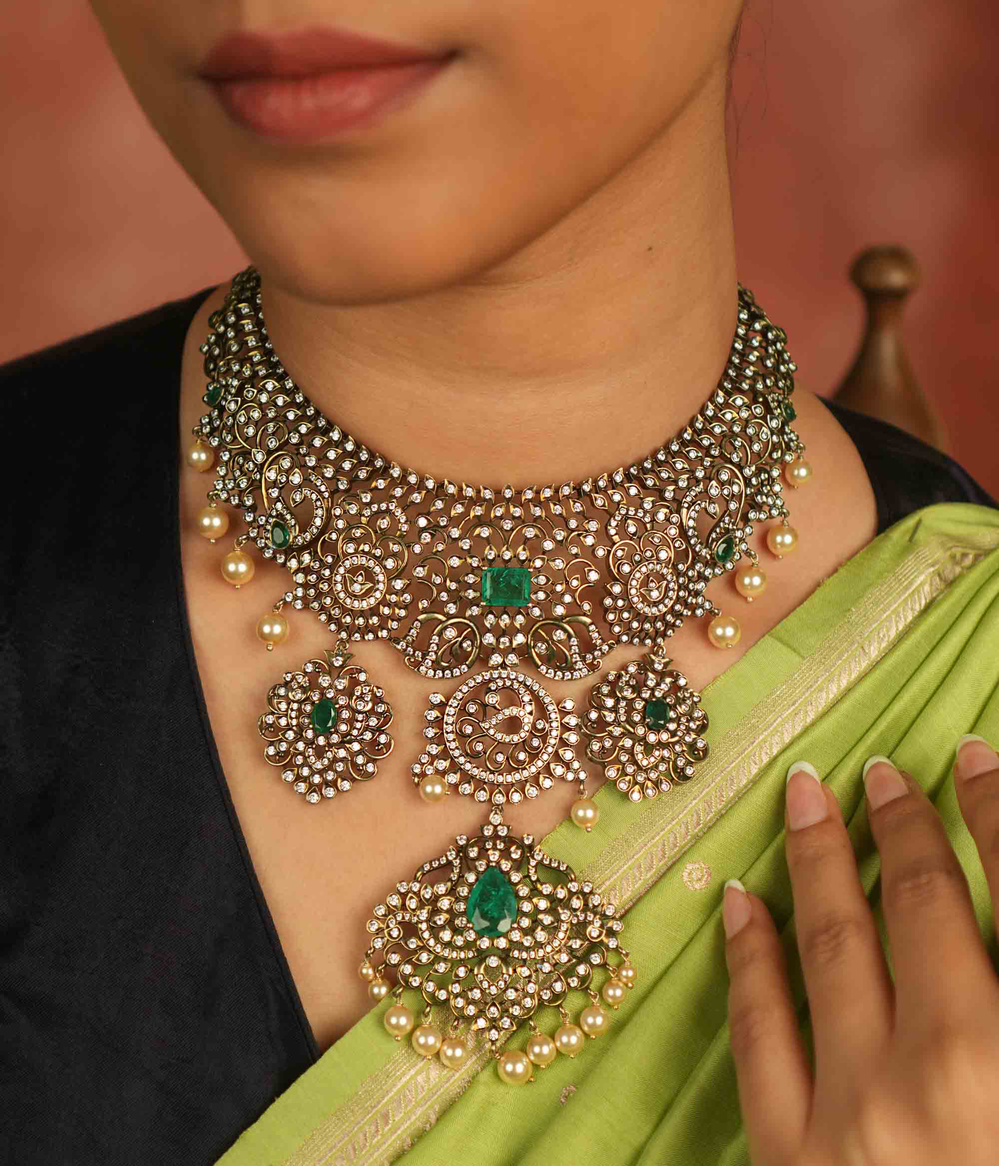 Victorian elegance reborn! This moissanite necklace with floral patterns, green-cut stones, CZ brilliance, and pearl droplets whispers timeless opulence.